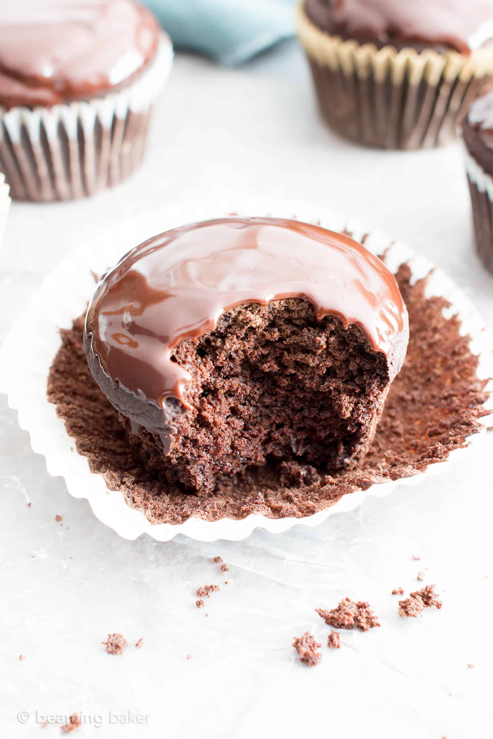 Chocolate Ganache Cupcakes (V, GF): an easy recipe for perfectly moist chocolate cupcakes covered in a thick layer of rich chocolate ganache! #Vegan #GlutenFree #DairyFree #Chocolate #Dessert | Recipe on BeamingBaker.com