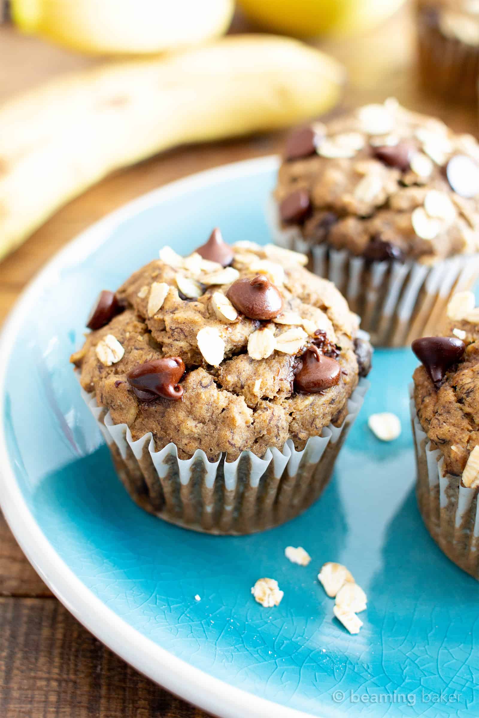 Banana Oatmeal Chocolate Chip Muffins (V, GF): a healthy 1-bowl recipe for moist, satisfying fresh-baked banana muffins bursting with hearty oats and decadent chocolate chips. #Bananas #Vegan #GlutenFree #Muffins #Healthy #Oats | Recipe at BeamingBaker.com