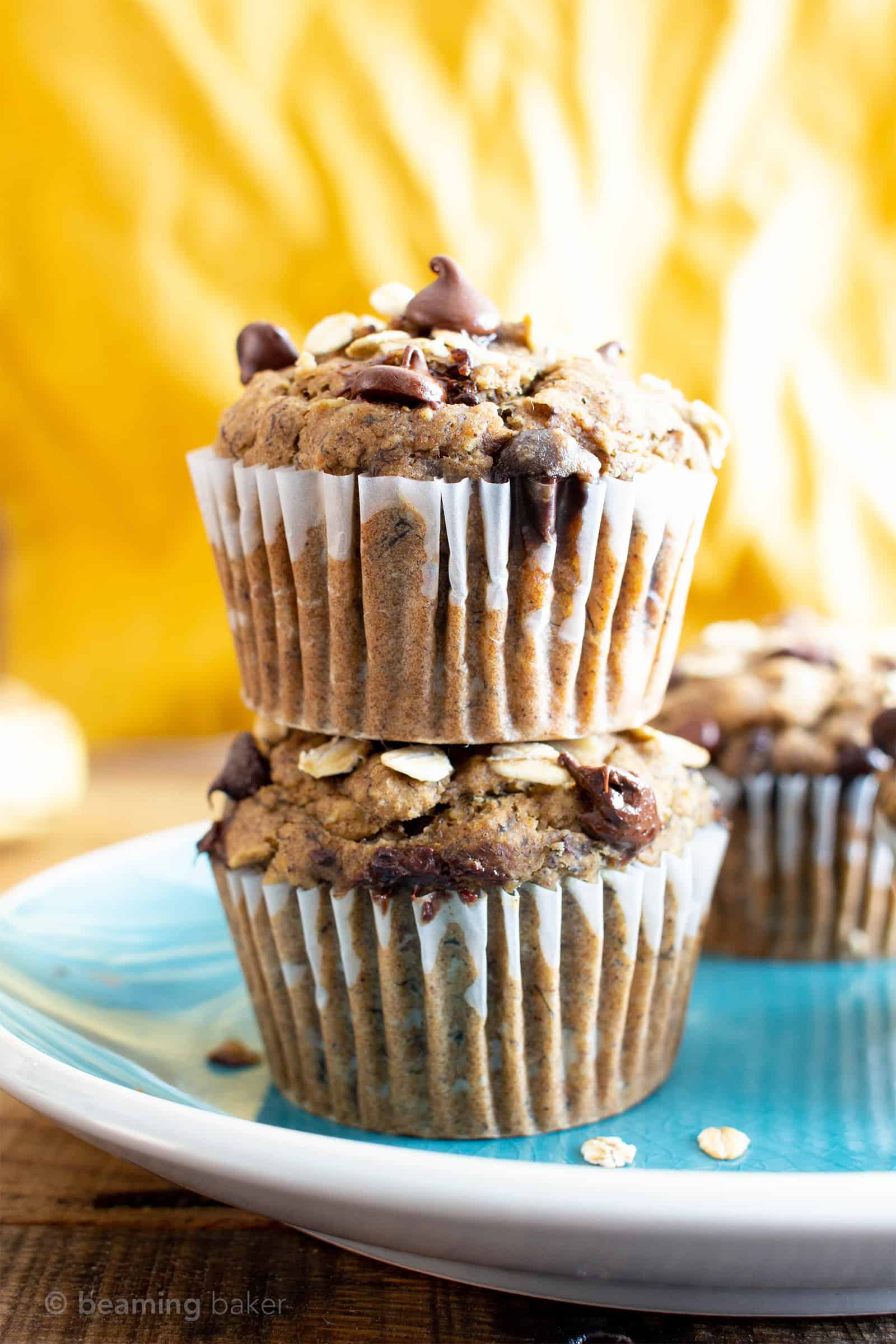 Banana Oatmeal Chocolate Chip Muffins (V, GF): a healthy 1-bowl recipe for moist, satisfying fresh-baked banana muffins bursting with hearty oats and decadent chocolate chips. #Bananas #Vegan #GlutenFree #Muffins #Healthy #Oats | Recipe at BeamingBaker.com