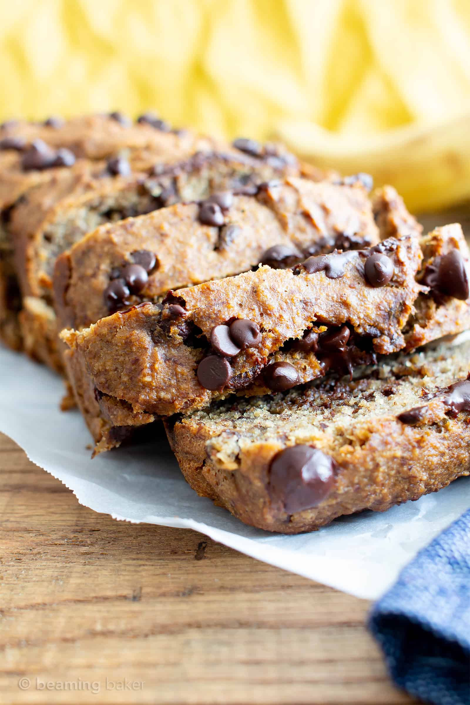 Best Moist Chocolate Chip Banana Bread Recipe (V, GF): a one bowl recipe for deliciously moist banana bread bursting with chocolate and made with healthy, whole ingredients. #Vegan #GlutenFree #DairyFree #Healthy #QuickBreads | Recipe at BeamingBaker.com