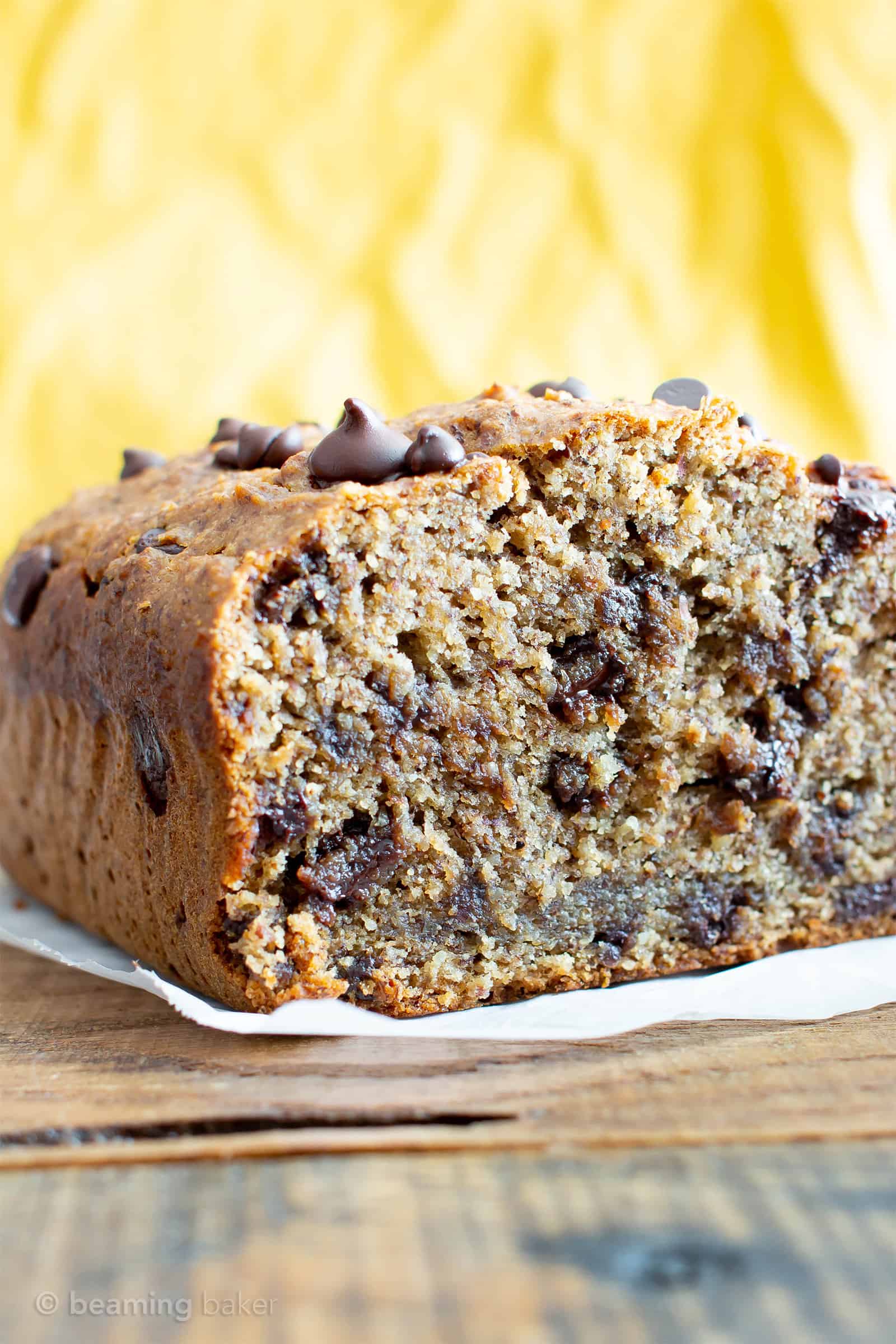 Best Moist Chocolate Chip Banana Bread Recipe (V, GF): a one bowl recipe for deliciously moist banana bread bursting with chocolate and made with healthy, whole ingredients. #Vegan #GlutenFree #DairyFree #Healthy #QuickBreads | Recipe at BeamingBaker.com