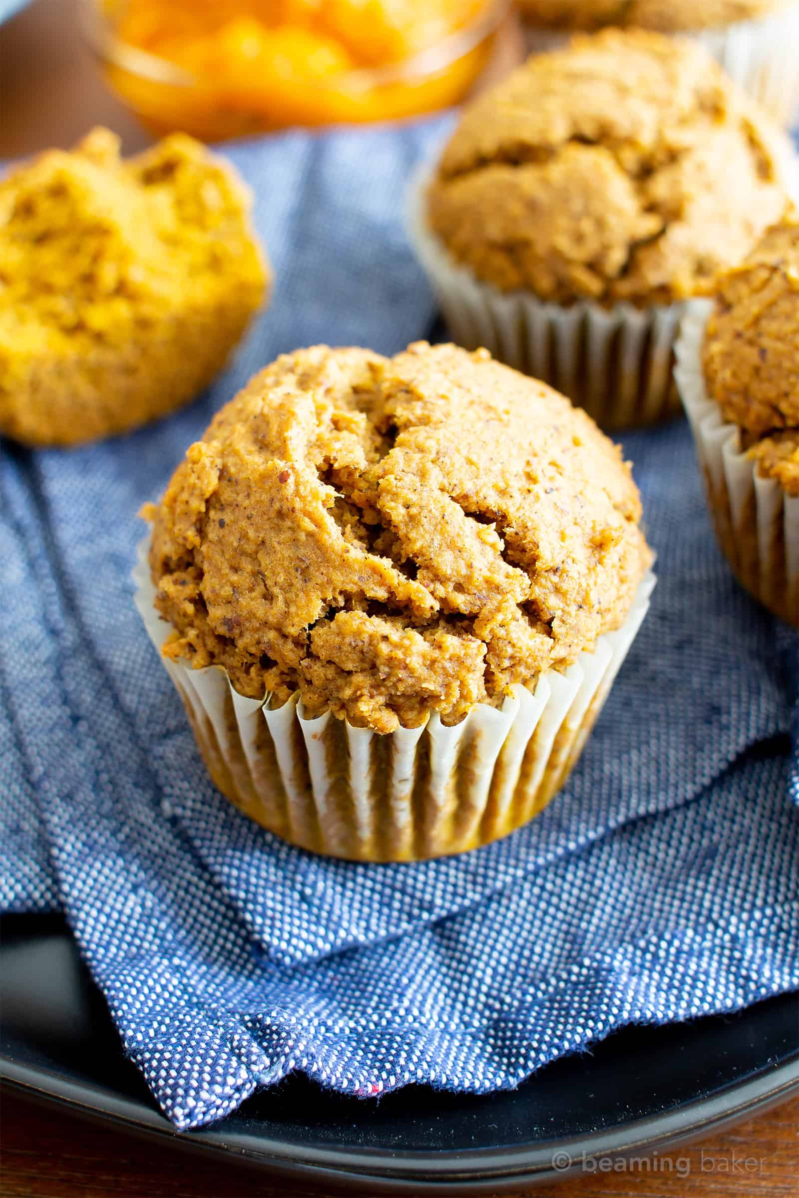 Easy Vegan Gluten Free Pumpkin Muffins Recipe (V, GF): an easy recipe for moist ‘n fluffy pumpkin muffins bursting with your favorite fall spices. Made with healthy, whole ingredients. #Vegan #GlutenFree #Pumpkin #Muffins #PumpkinSpice #DairyFree #Healthy #Fall #RefinedSugarFree | Recipe at BeamingBaker.com