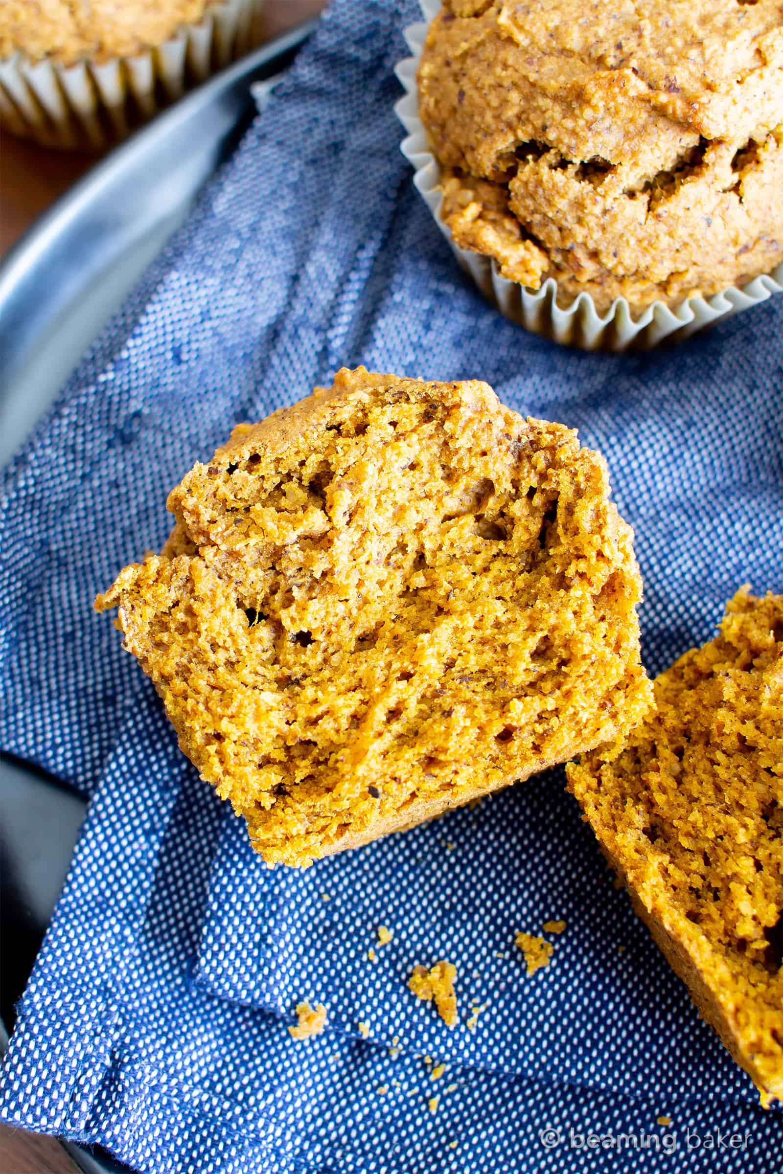 Easy Vegan Gluten Free Pumpkin Muffins Recipe (V, GF): an easy recipe for moist ‘n fluffy pumpkin muffins bursting with your favorite fall spices. Made with healthy, whole ingredients. #Vegan #GlutenFree #Pumpkin #Muffins #PumpkinSpice #DairyFree #Healthy #Fall #RefinedSugarFree | Recipe at BeamingBaker.com