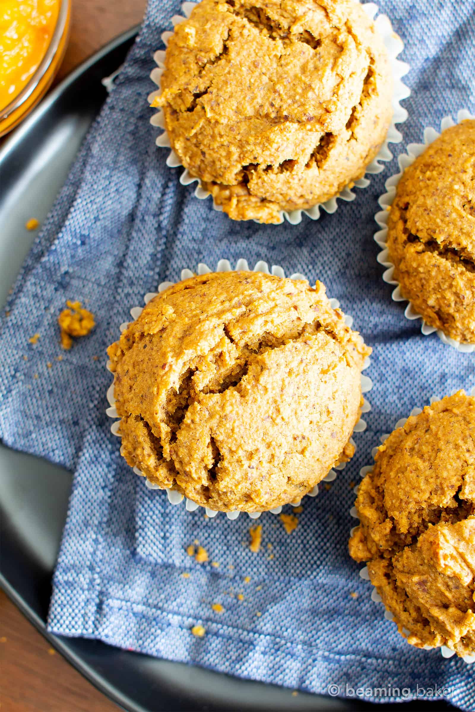Easy Vegan Gluten Free Pumpkin Muffins Recipe (V, GF): an easy recipe for moist ‘n fluffy pumpkin muffins bursting with your favorite fall spices. Made with healthy, whole ingredients. #Vegan #GlutenFree #Pumpkin #Muffins #PumpkinSpice #DairyFree #Healthy #Fall #RefinedSugarFree | Recipe at BeamingBaker.com