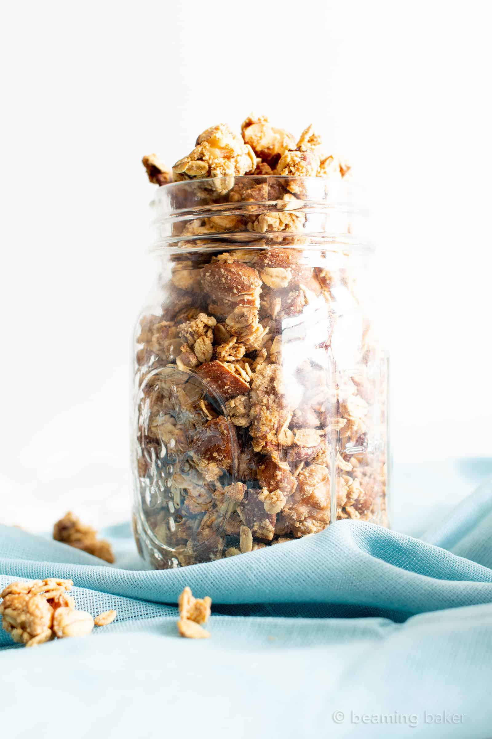 A jar topped full with gluten free granola.