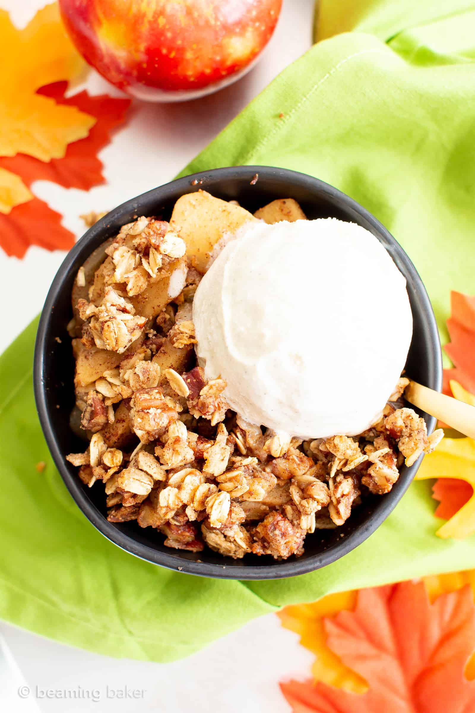 Vegan Gluten Free Cinnamon Apple Crisp with Oats (V, GF): an easy recipe for a warm, gooey apple crisp with delicious cinnamon oat topping. Made with healthy ingredients. #Vegan #GlutenFree #GlutenFreeVegan #AppleCrisp #HealthyDesserts #Fall | Recipe at BeamingBaker.com