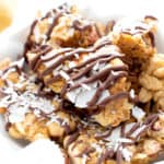 Drizzled Peanut Butter Coconut Oatmeal Clusters Recipe (V, GF): big clusters of peanut butter & oatmeal, topped with coconut and layers of drizzled chocolate! Perfect for gift giving this holiday season! Made with healthy ingredients. #Vegan #GlutenFree #VeganGlutenFree #BeamingBaker #PeanutButter #HealthyDesserts | Recipe at BeamingBaker.com