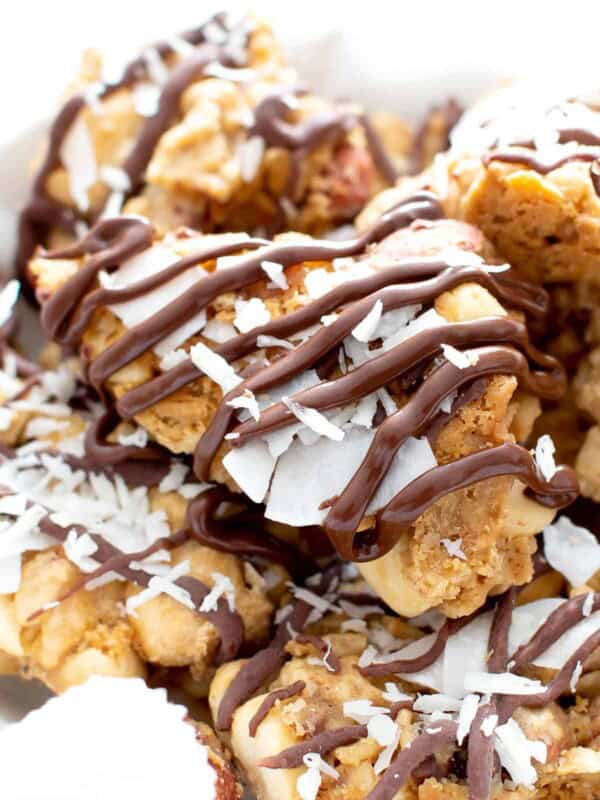 Drizzled Peanut Butter Coconut Oatmeal Clusters Recipe (V, GF): big clusters of peanut butter & oatmeal, topped with coconut and layers of drizzled chocolate! Perfect for gift giving this holiday season! Made with healthy ingredients. #Vegan #GlutenFree #VeganGlutenFree #BeamingBaker #PeanutButter #HealthyDesserts | Recipe at BeamingBaker.com