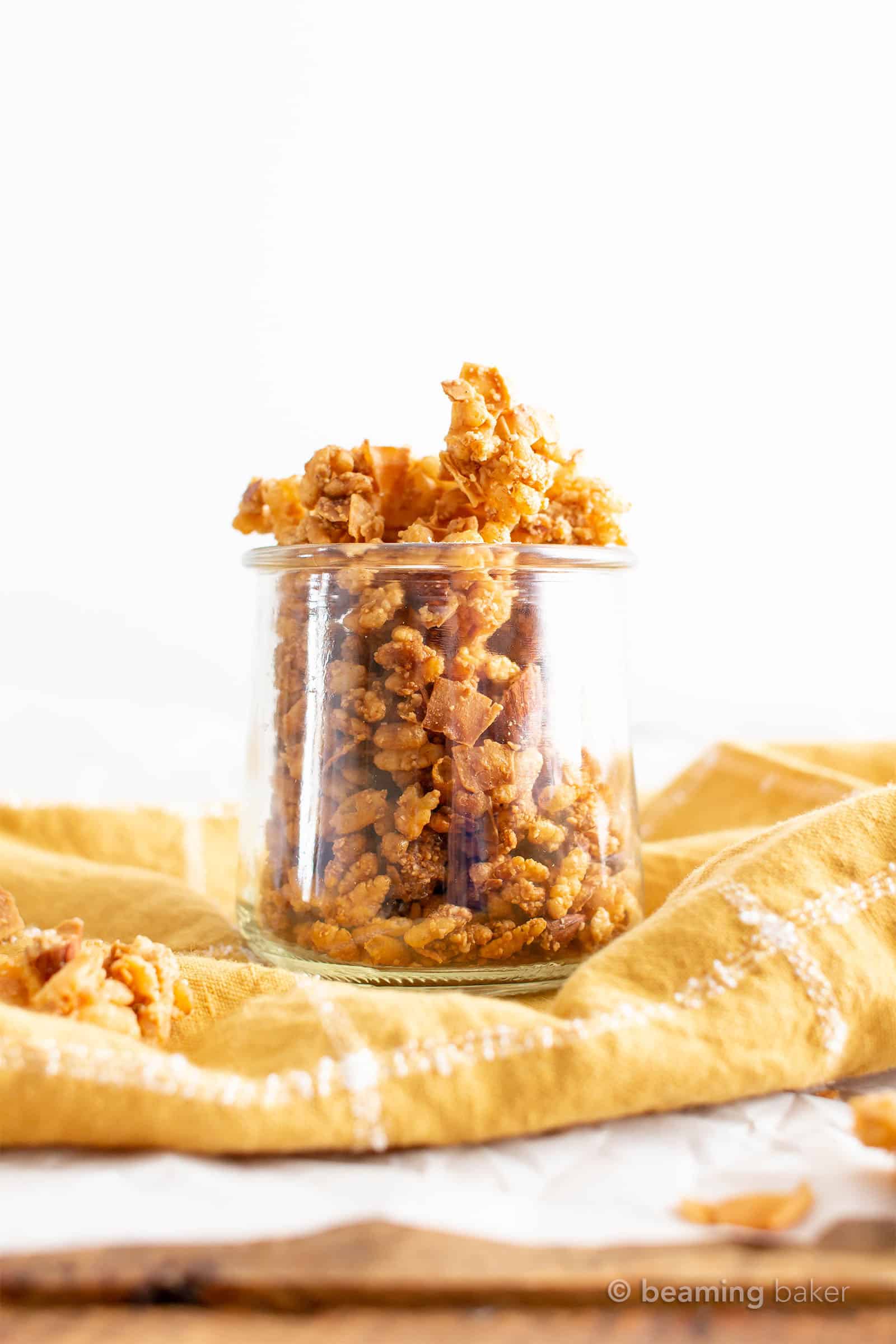 Low Calorie Granola: 5 mins of prep for the best low carb, low sugar, low fat granola! Crispy, crunchy and perfectly sweet. Only 74 calories, 3.6g of sugar and 7g carbs per serving. #LowCalorie #Granola #LowCarb #LowFat #LowSugar | Recipe at BeamingBaker.com