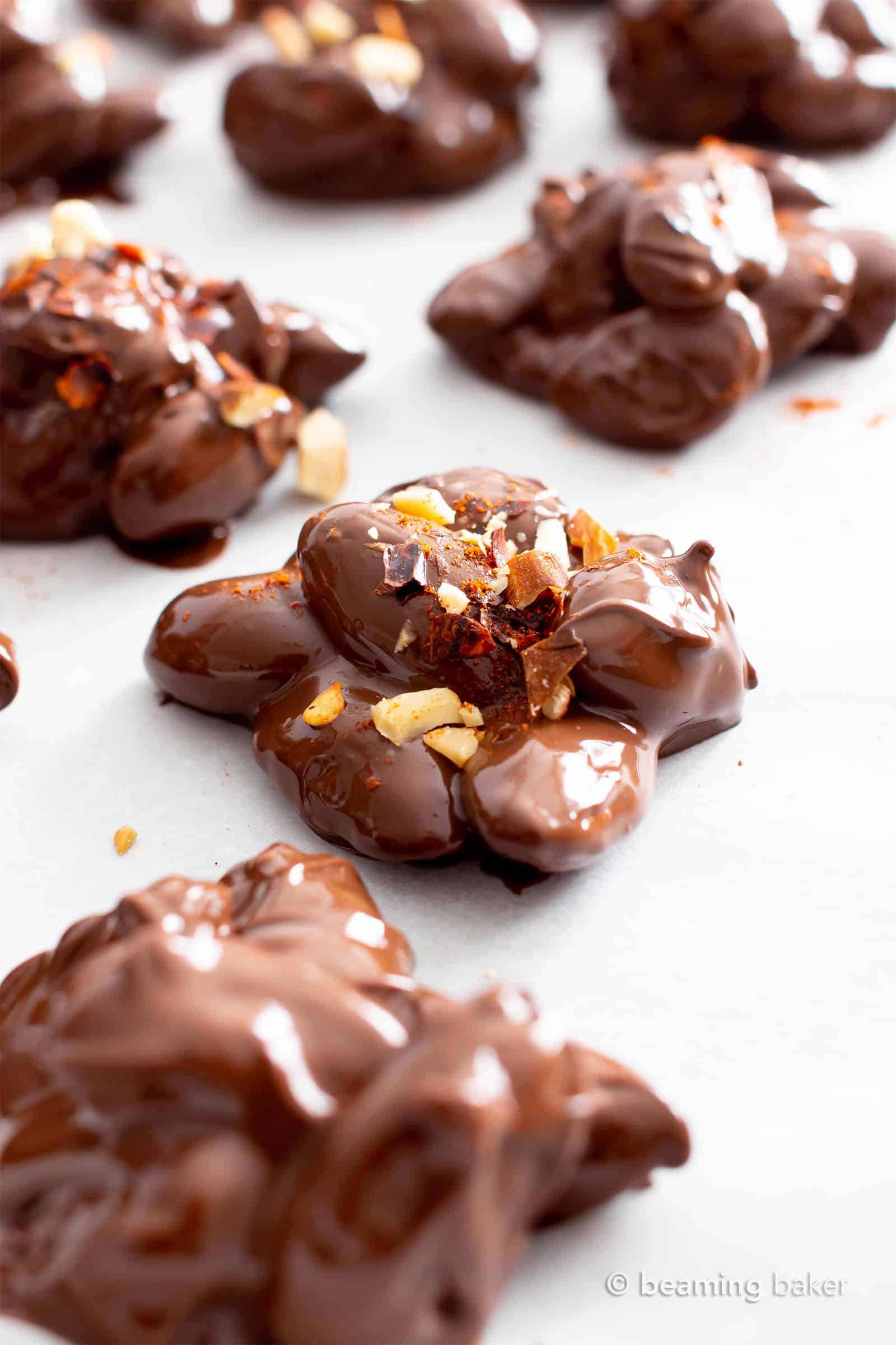 Dark Chocolate Chili Nut Clusters Recipe (V, GF): this homemade chocolate nut clusters recipe is healthy, easy and decadent! It’s the perfect dark chocolate treat – spicy, rich, packed with sweet nut clusters & prep’d in 15 minutes! #Chocolate #Vegan #Dessert #Nuts | Recipe at BeamingBaker.com