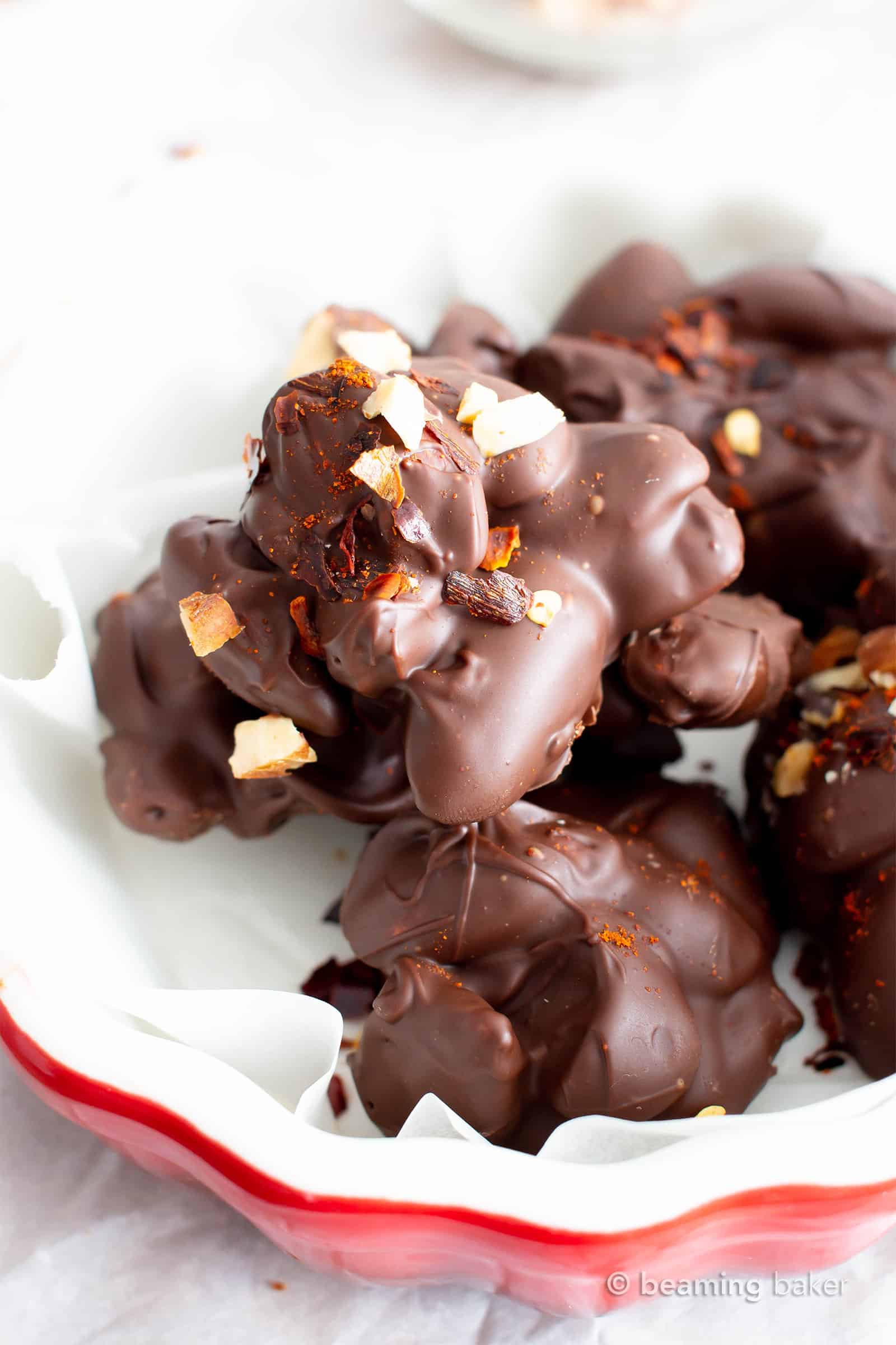 Dark Chocolate Chili Nut Clusters Recipe (V, GF): this homemade chocolate nut clusters recipe is healthy, easy and decadent! It’s the perfect dark chocolate treat – spicy, rich, packed with sweet nut clusters & prep’d in 15 minutes! #Chocolate #Vegan #Dessert #Nuts | Recipe at BeamingBaker.com