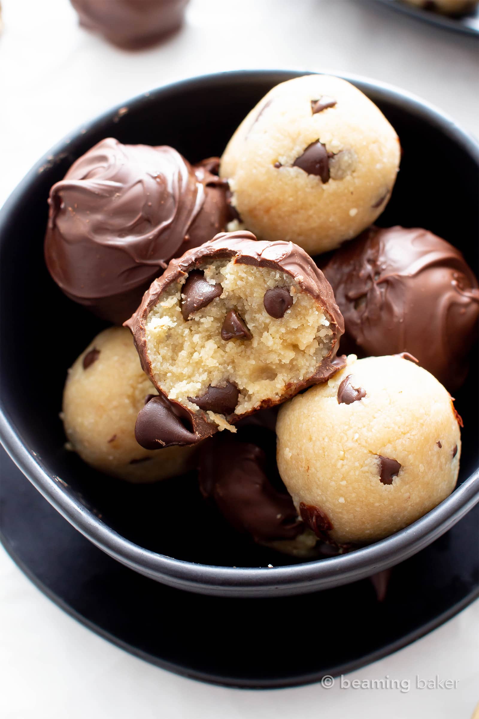 Paleo Chocolate Chip Cookie Dough Truffles (V, GF): this rich ‘n satisfying vegan cookie dough truffle recipe is perfect for gift-giving! It’s the ultimate edible paleo cookie dough dessert – easy to make and healthy! #CookieDough #Paleo #Dessert #Chocolate | Recipe at BeamingBaker.com