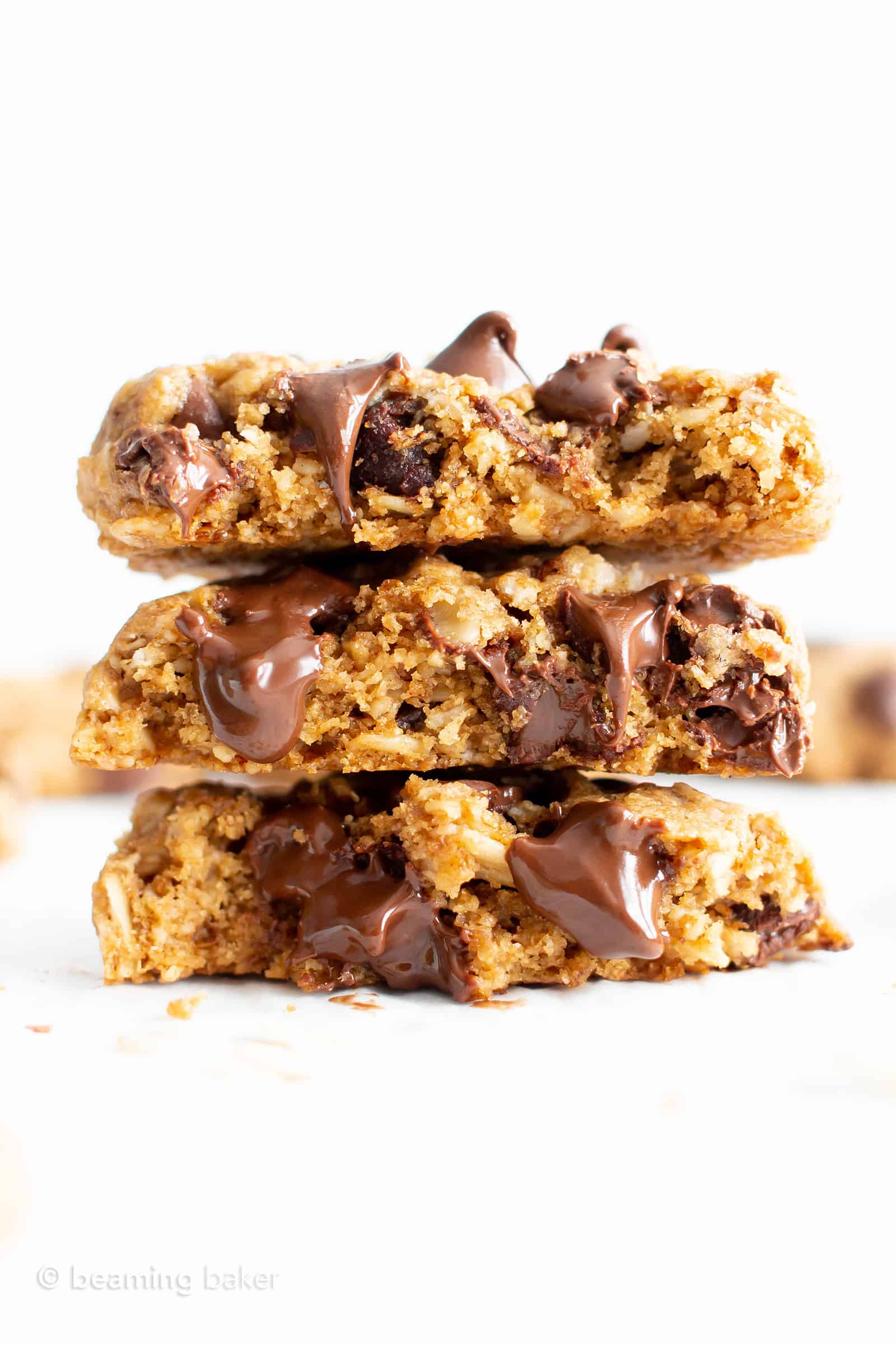 Stack of three gluten free oatmeal cookies with melty chocolate chips.