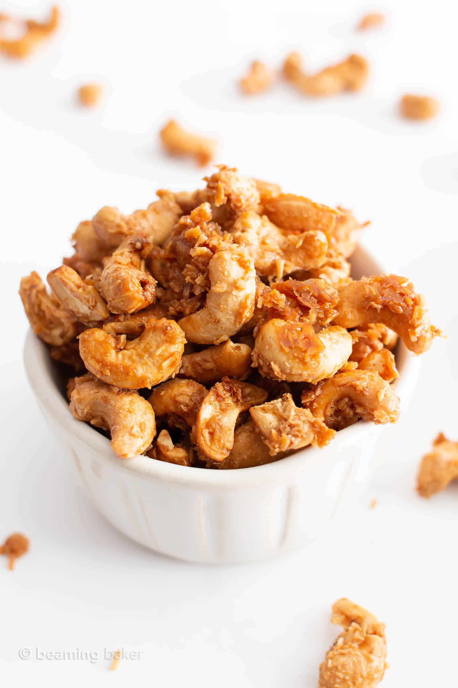 4 Ingredient Toasted Coconut Cashews Recipe (Paleo, GF): this vegan toasted coconut cashews recipe is gluten free & paleo! The crunchiest coconut coated roasted cashews, made with 4 ingredients. Dairy-Free. #Paleo #Cashews #Coconut #Vegan #GlutenFree | Recipe at BeamingBaker.com