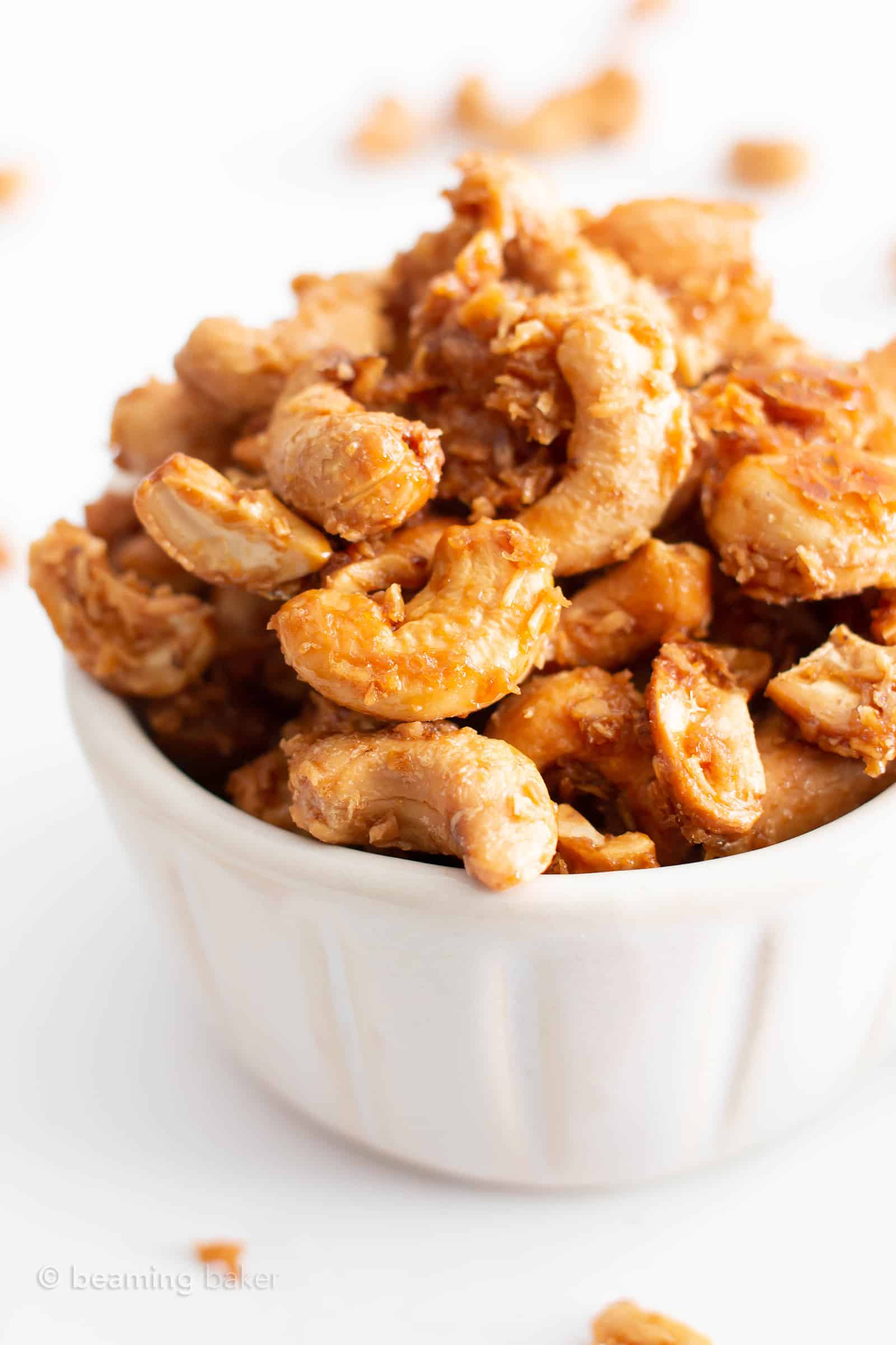 4 Ingredient Toasted Coconut Cashews Recipe (Paleo, GF): this vegan toasted coconut cashews recipe is gluten free & paleo! The crunchiest coconut coated roasted cashews, made with 4 ingredients. Dairy-Free. #Paleo #Cashews #Coconut #Vegan #GlutenFree | Recipe at BeamingBaker.com