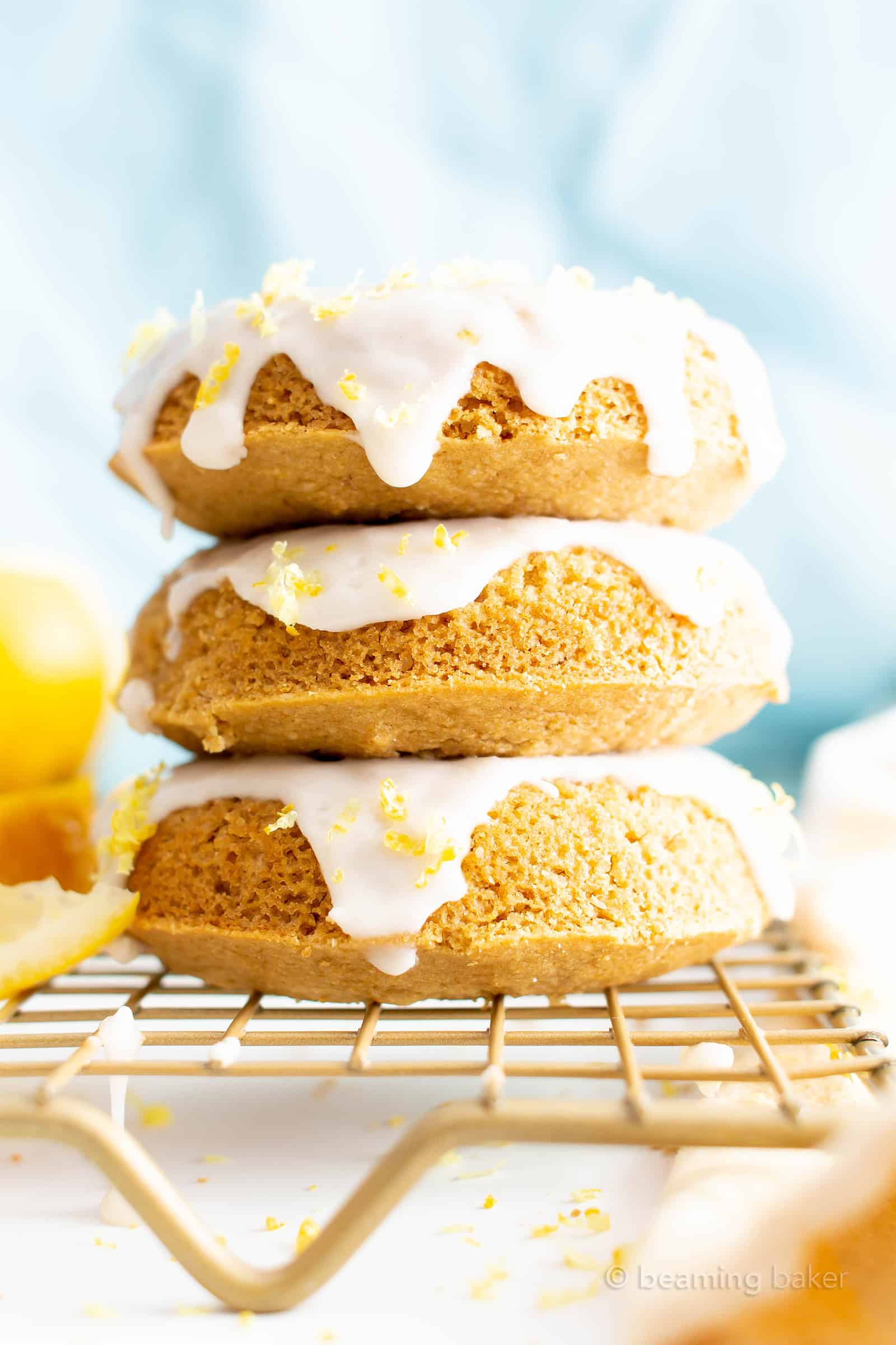 Vegan Soft Baked Lemon Donuts with Lemon Glaze (GF): this vegan gluten free donuts recipe yields soft and fluffy donuts with easy homemade lemon glaze! Healthy Doughnuts, Dairy-Free, Refined Sugar-Free. #Vegan #Donuts #Lemon #GlutenFree #DairyFree | Recipe at BeamingBaker.com