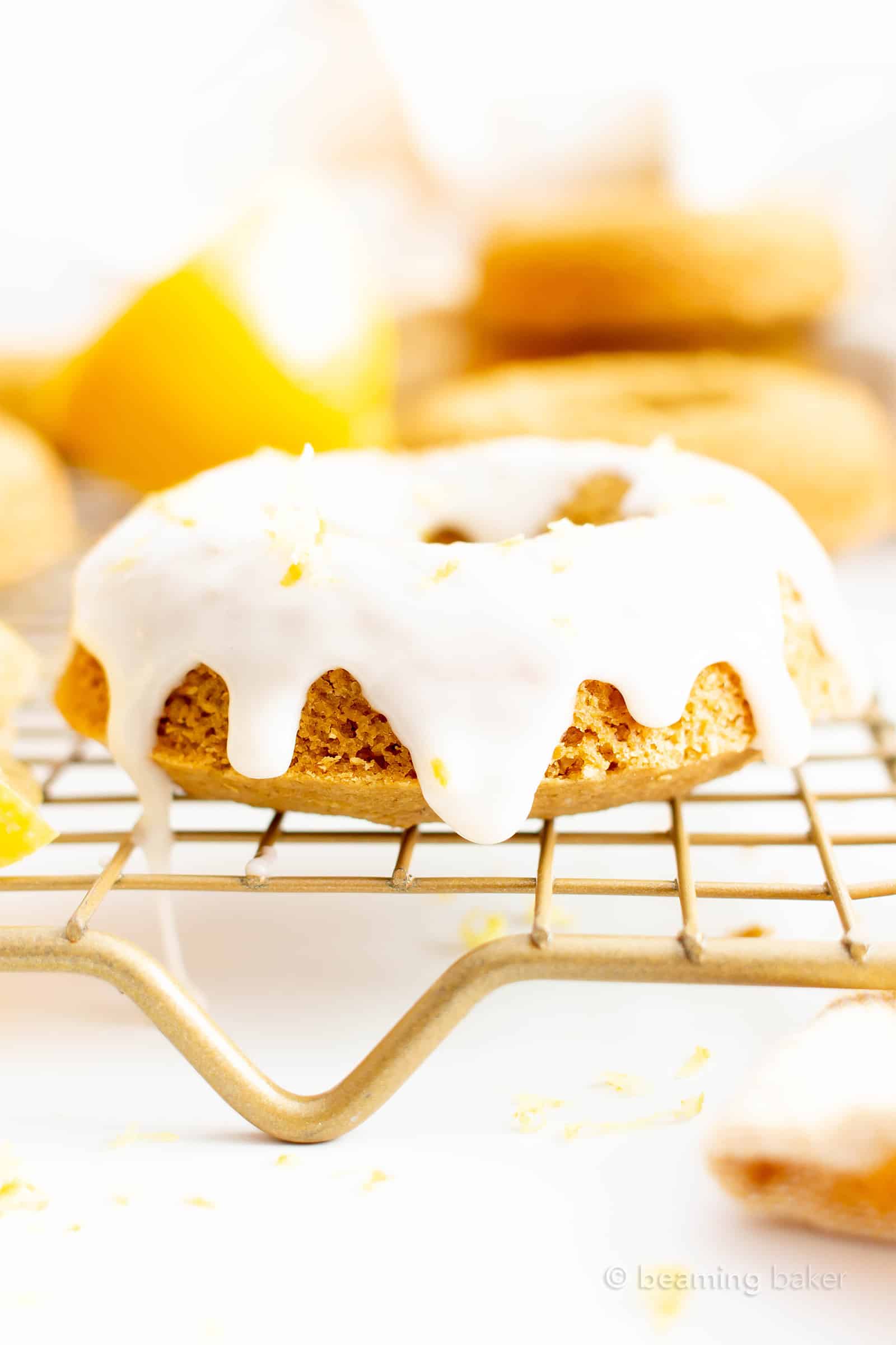 Vegan Soft Baked Lemon Donuts with Lemon Glaze (GF): this vegan gluten free donuts recipe yields soft and fluffy donuts with easy homemade lemon glaze! Healthy Doughnuts, Dairy-Free, Refined Sugar-Free. #Vegan #Donuts #Lemon #GlutenFree #DairyFree | Recipe at BeamingBaker.com
