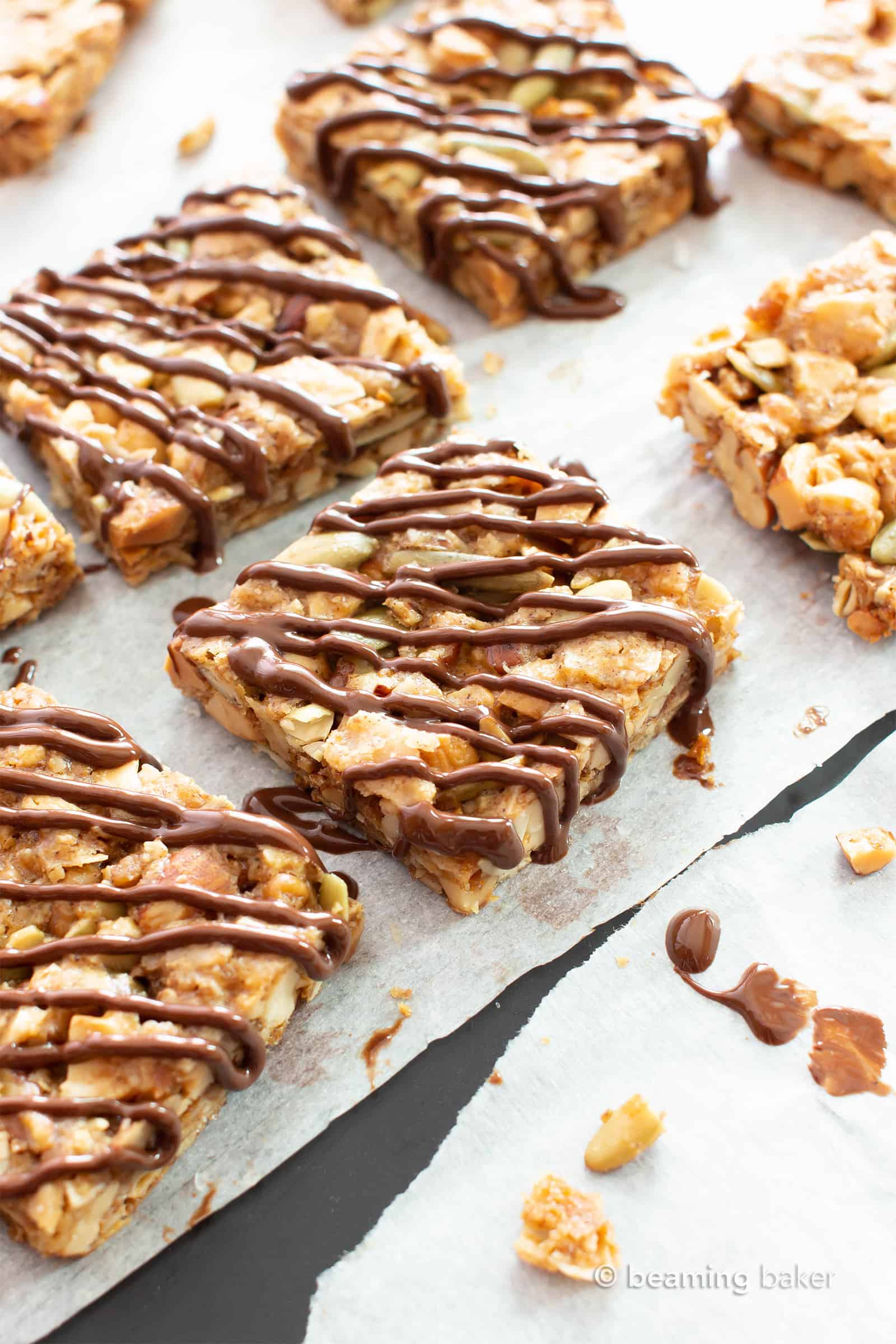 Dark Chocolate Paleo Snack Bars (GF): this chocolate-drizzled vegan snack bars recipe is chewy & satisfying! The best gluten free snack bars—grain-free, refined sugar-free & healthy! #SnackBars #GlutenFree #Paleo #Vegan #Healthy | Recipe at BeamingBaker.com