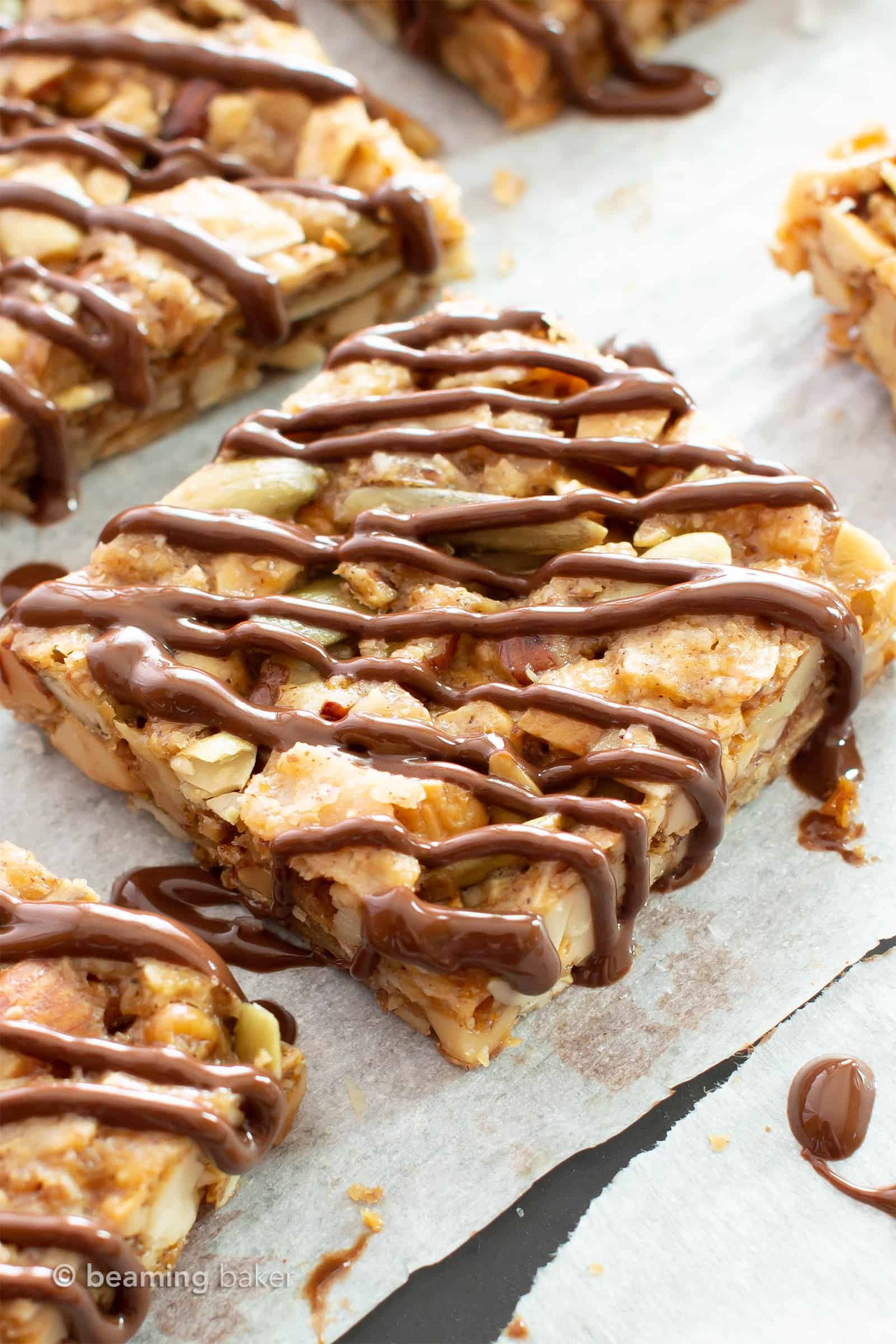 Dark Chocolate Paleo Snack Bars (GF): this chocolate-drizzled vegan snack bars recipe is chewy & satisfying! The best gluten free snack bars—grain-free, refined sugar-free & healthy! #SnackBars #GlutenFree #Paleo #Vegan #Healthy | Recipe at BeamingBaker.com