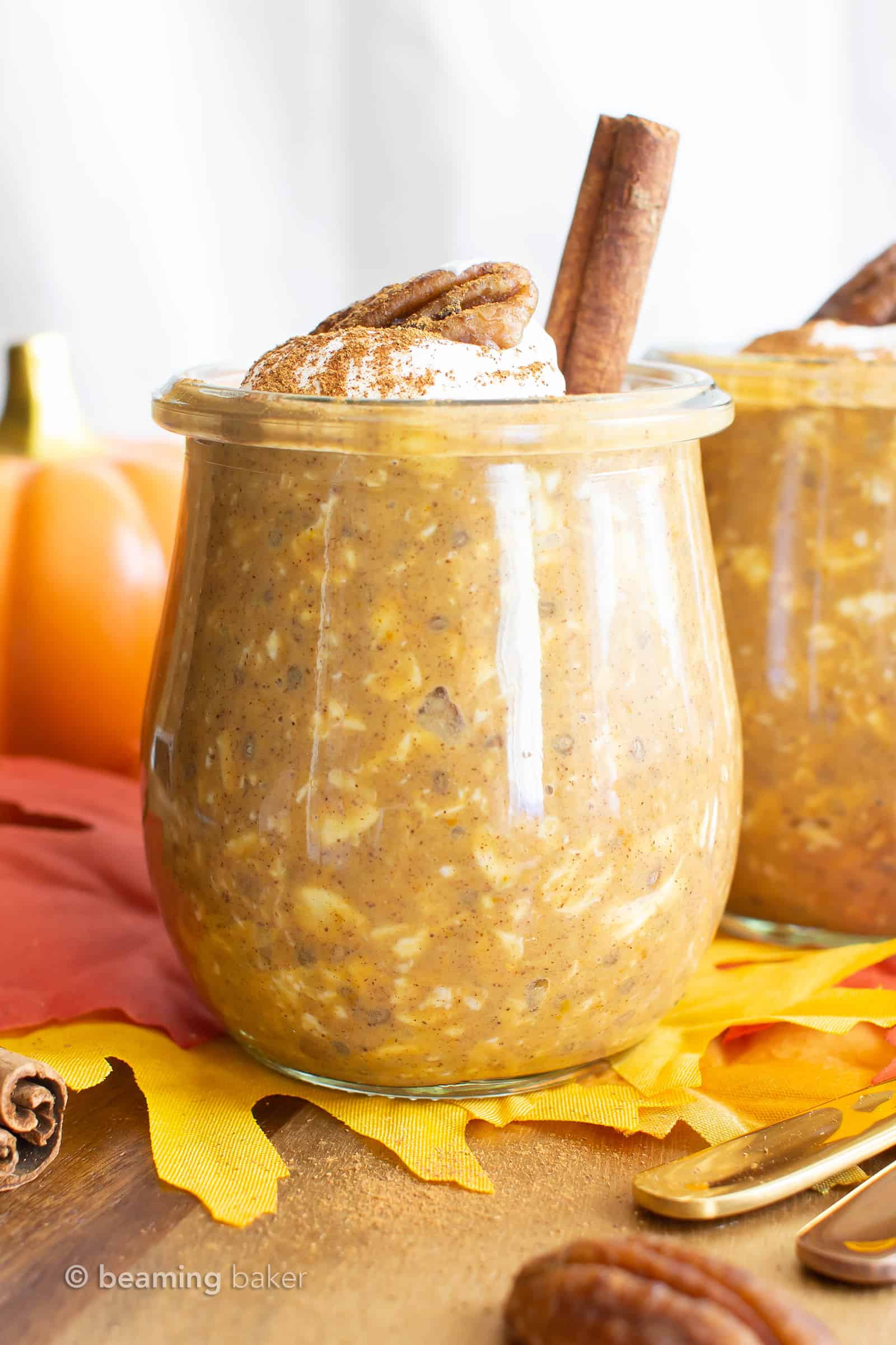 pumpkin overnight oats in a jar topped with whipped cream