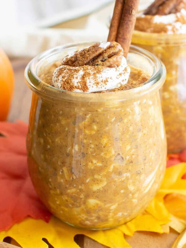 Pumpkin Overnight Oats in two jars with fall decor