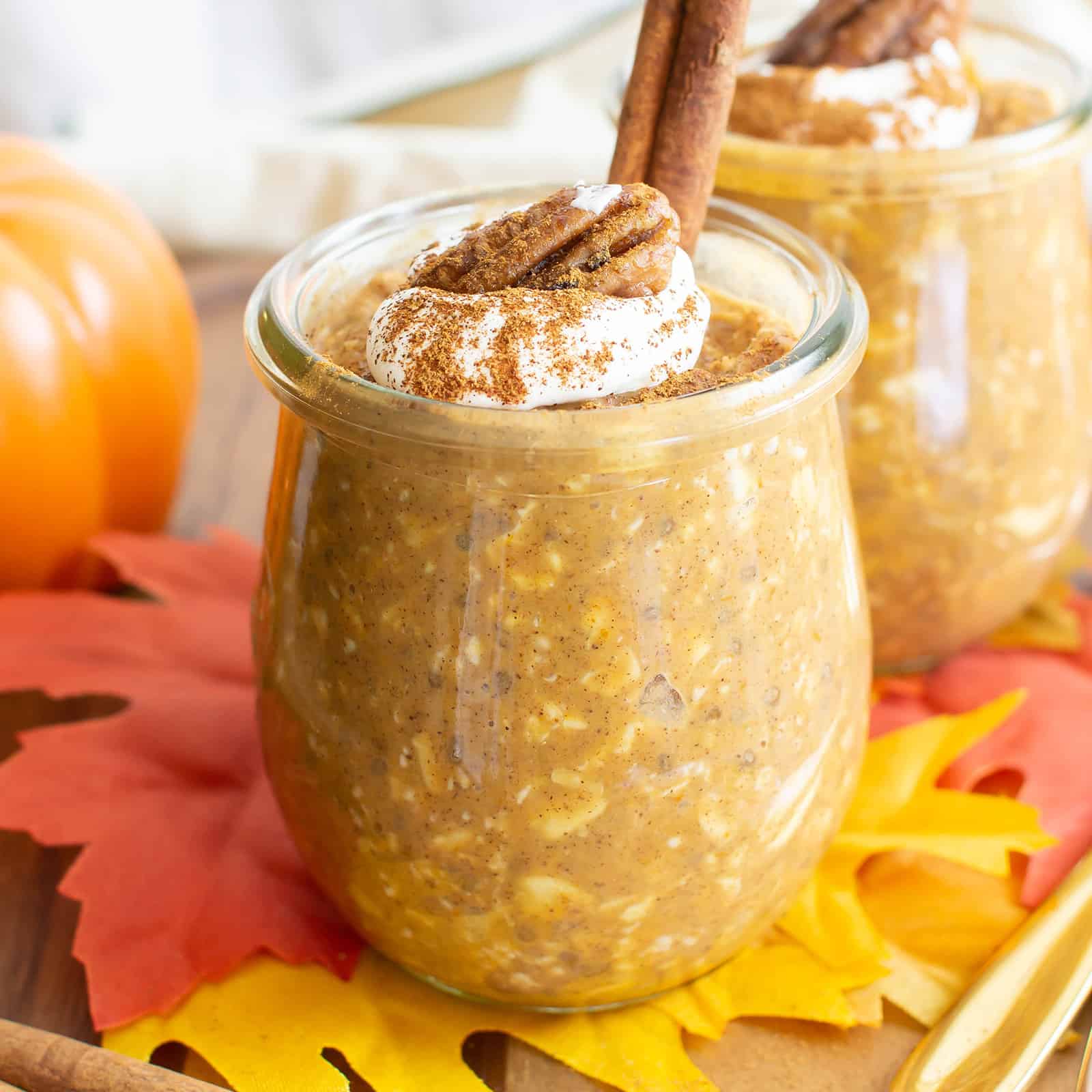 Pumpkin Overnight Oats in two jars with fall decor