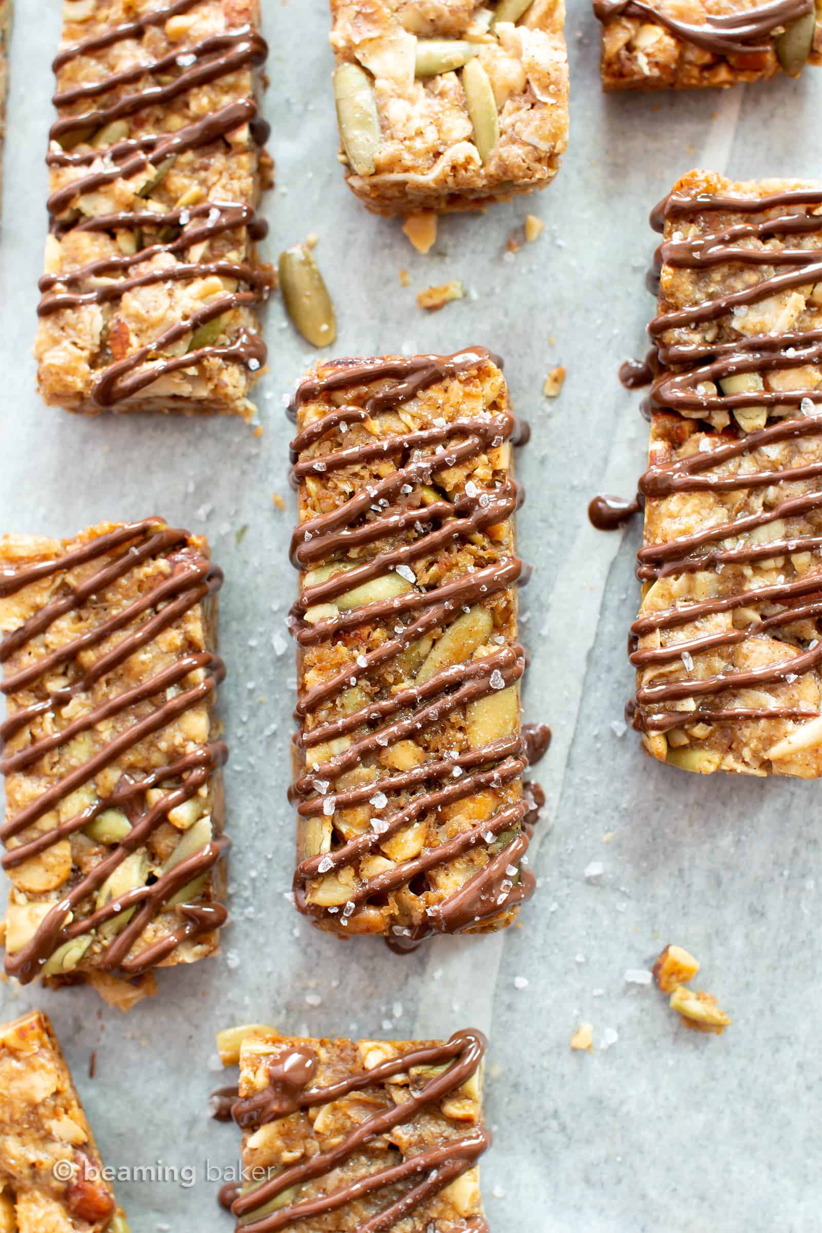 Sea Salt Chocolate Paleo Granola Bars Recipe (GF): this grain free granola bars recipe is easy & delicious! The BEST salty & sweet gluten free granola bars—super nutty, drizzled with chocolate & topped with sea salt. #Paleo #GrainFree #GlutenFree #Vegan #GranolaBars | Recipe at BeamingBaker.com