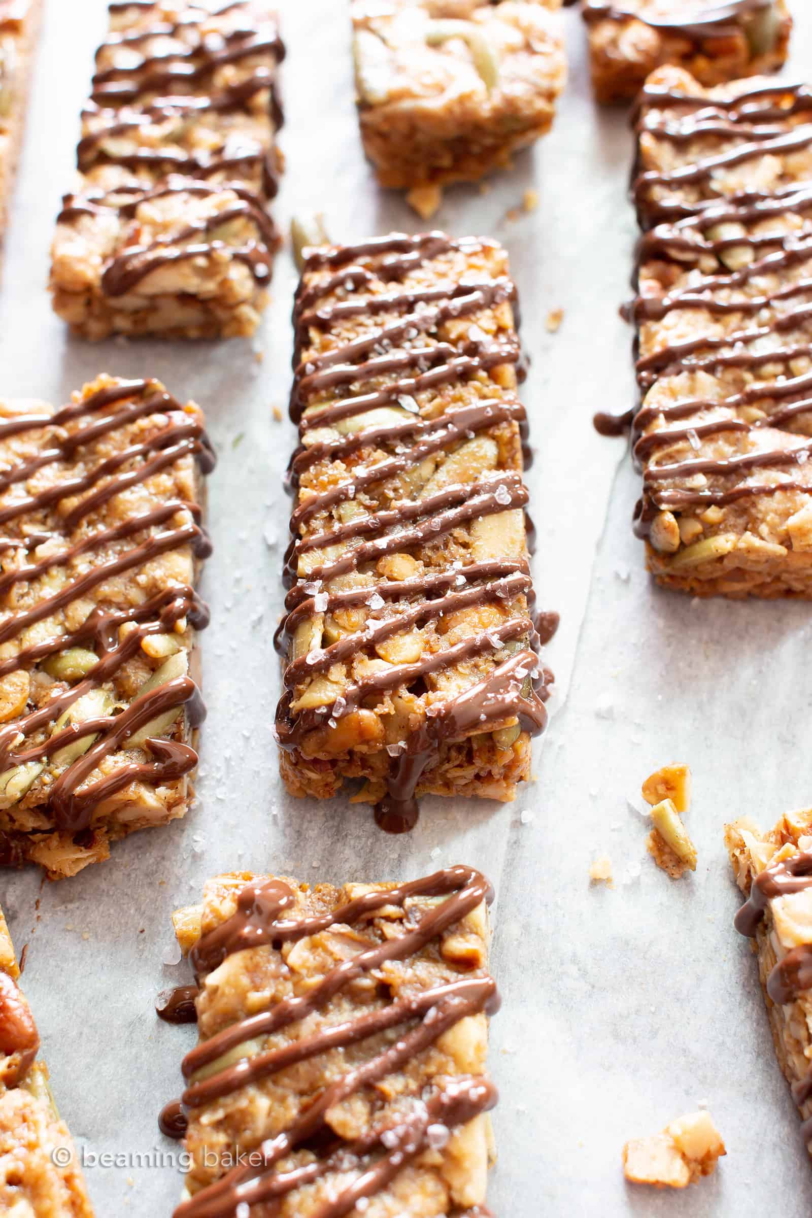 Sea Salt Chocolate Paleo Granola Bars Recipe (GF): this grain free granola bars recipe is easy & delicious! The BEST salty & sweet gluten free granola bars—super nutty, drizzled with chocolate & topped with sea salt. #Paleo #GrainFree #GlutenFree #Vegan #GranolaBars | Recipe at BeamingBaker.com