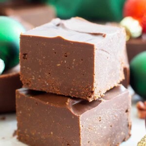 two pieces of keto fudge in a stack with ornaments