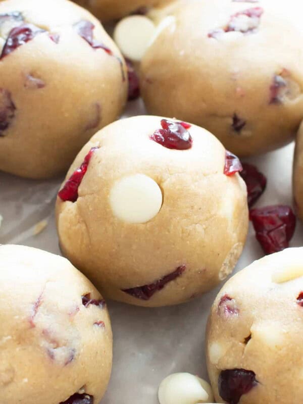 White Chocolate Cranberry Cookie Dough Bites (GF): this easy, no bake recipe for Vegan + Gluten Free cookie dough balls is deliciously sweet & tart! White chocolate chips & dried cranberries complement soft vegan cookie dough. Dairy-Free. #CookieDough #NoBake #Vegan #GlutenFree #Cranberries | Recipe at BeamingBaker.com