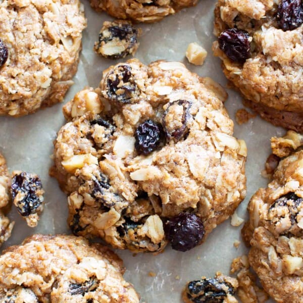 The BEST VEGAN chewy oatmeal raisin cookies EVER--crispy edges with a CHEWY center, bursting with oats, warm spices & juicy raisins! Gluten-Free, Healthy Ingredients! #Vegan #Cookies #OatmealRaisin #GlutenFree | Recipe at BeamingBaker.com