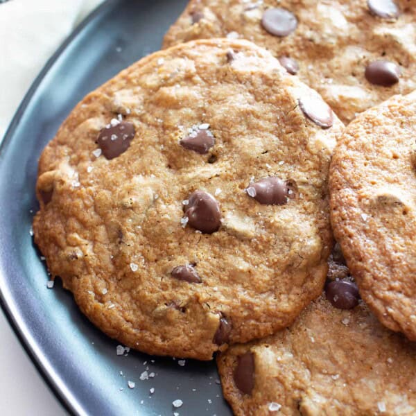 Sea Salt Thin Vegan Gluten Free Chocolate Chip Cookies Recipe (GF): SUPER Thin Vegan Chocolate Chip Cookies that are CRISPY throughout. Sprinkled with sparkling sea salt: the BEST Sweet & Salty gluten free chocolate chip cookies! #GlutenFree #Vegan #Cookies #Christmas #GlutenFreeVegan | Recipe at BeamingBaker.com