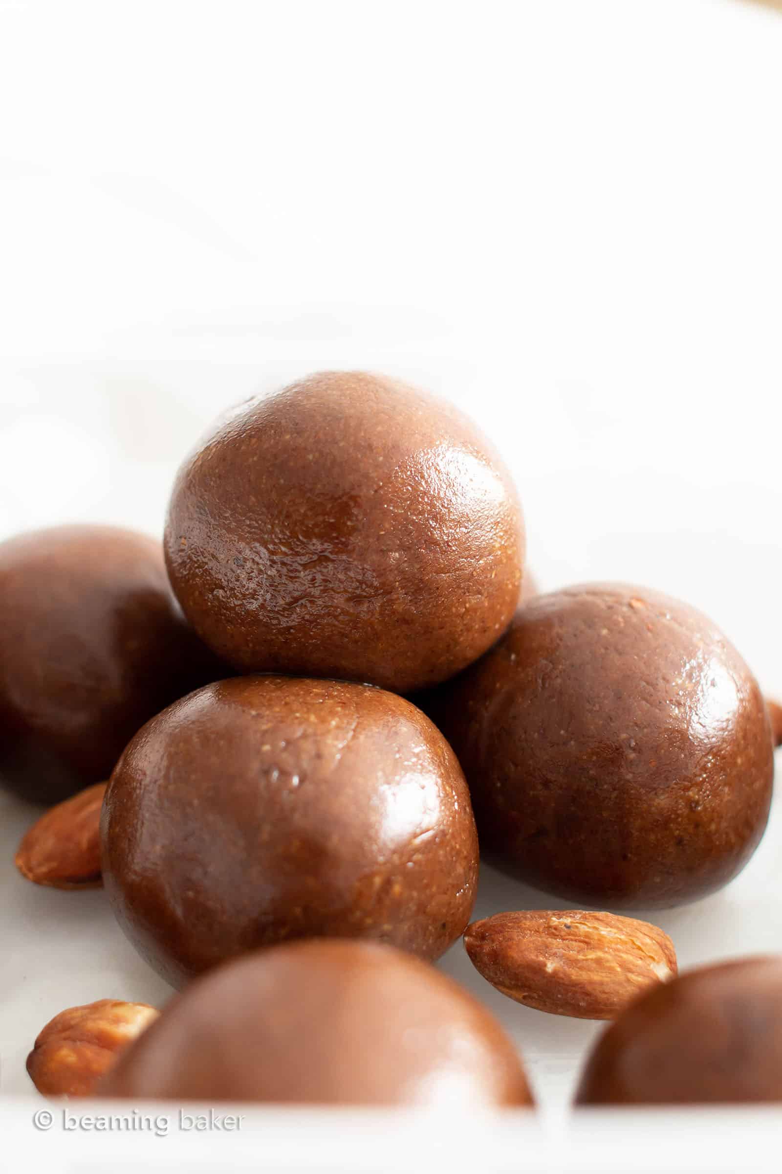 Paleo Energy Balls: just 4 ingredients for delicious, protein-packed healthy Almond Butter Balls—paleo recipe! These no bake energy balls are bursting with chocolate, vegan, gluten-free & dairy-free! #Paleo #Snacks #Vegan #GlutenFree | Recipe at BeamingBaker.com