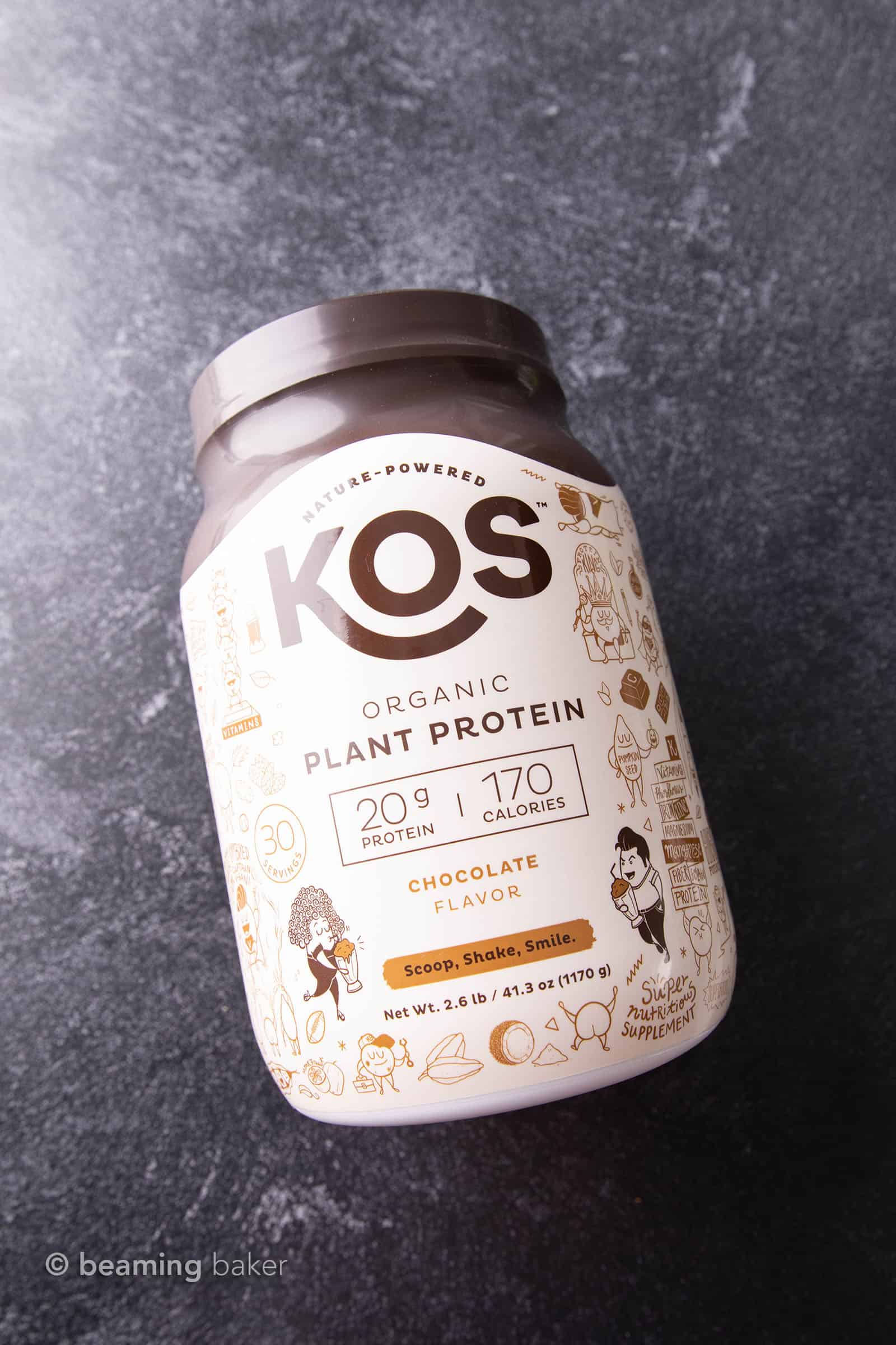 Container of KOS vegan chocolate protein powder on grey background