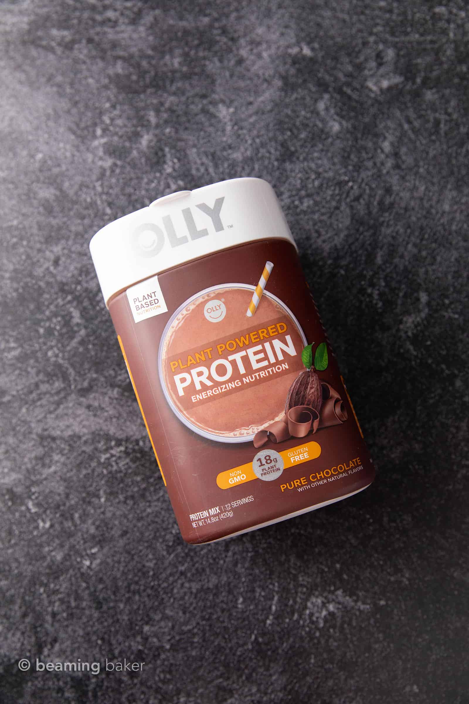 Container of OLLY vegan chocolate protein powder on grey background