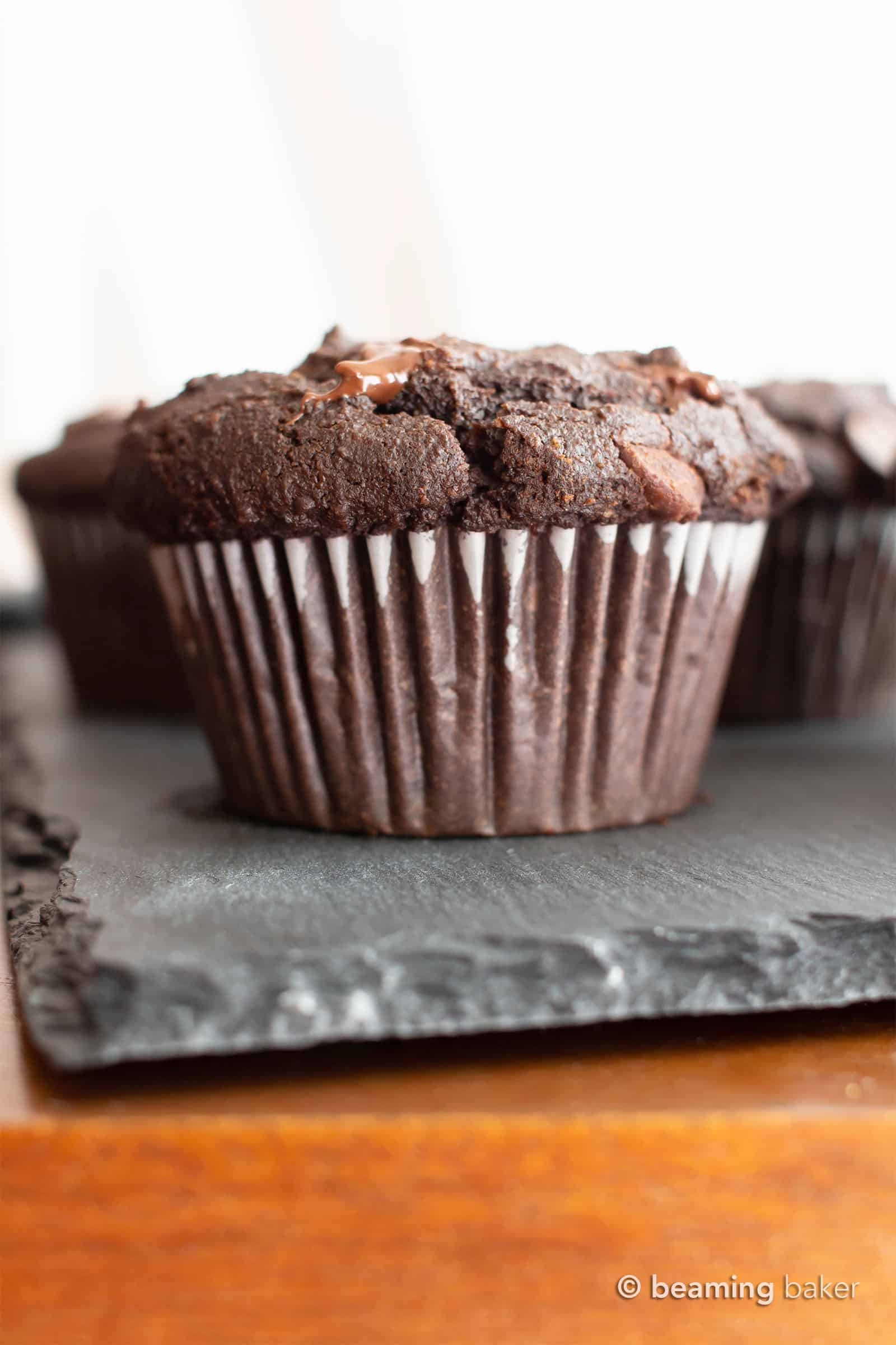 Paleo Chocolate Muffins: moist Gluten Free chocolate muffins with almond flour, tons of chocolate & crispy tops! Easy, Grain-Free, Vegan, Healthy ingredients. #Paleo #Muffins #GlutenFree #Chocolate | Recipe at BeamingBaker.com