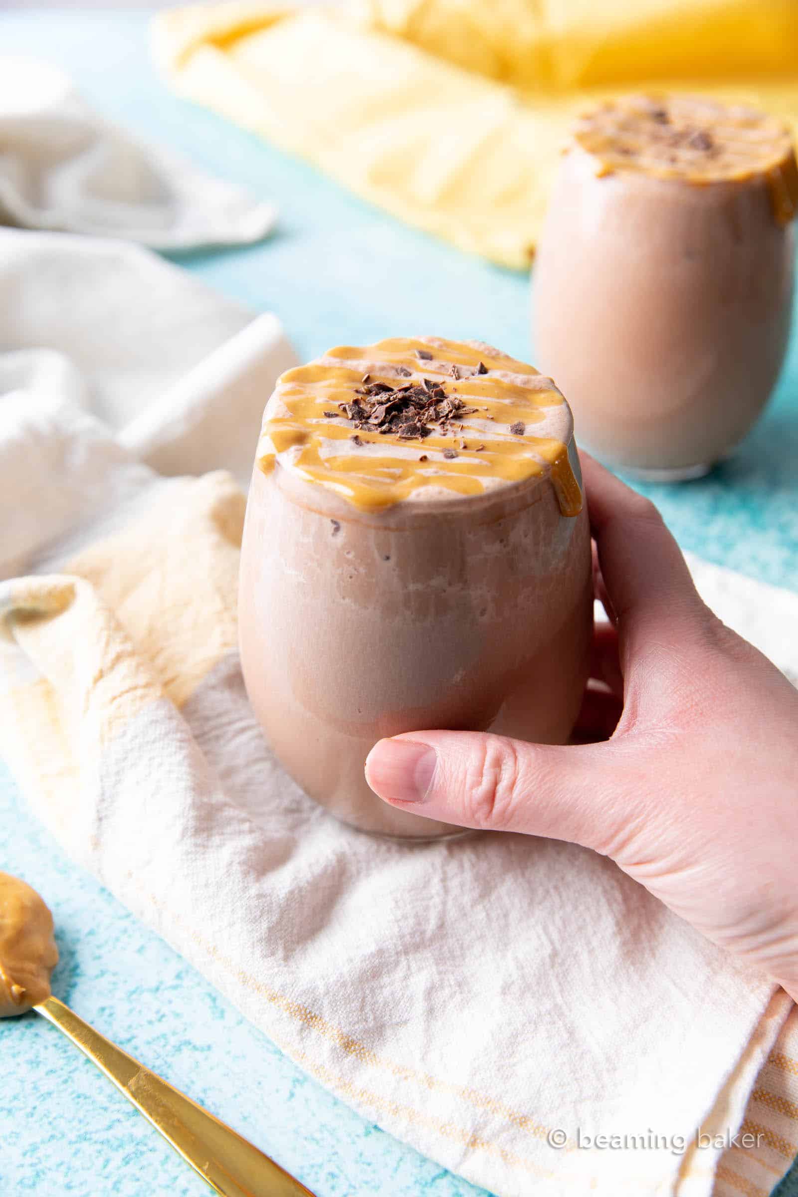 Chocolate Peanut Butter Protein Shake Recipe: this Vegan + High-Protein shake recipe requires just 5 ingredients & 5 minutes to make! Creamy peanut butter & chocolate YUM. #ProteinShake #Protein #Vegan #Chocolate #PeanutButter | Recipe at BeamingBaker.com