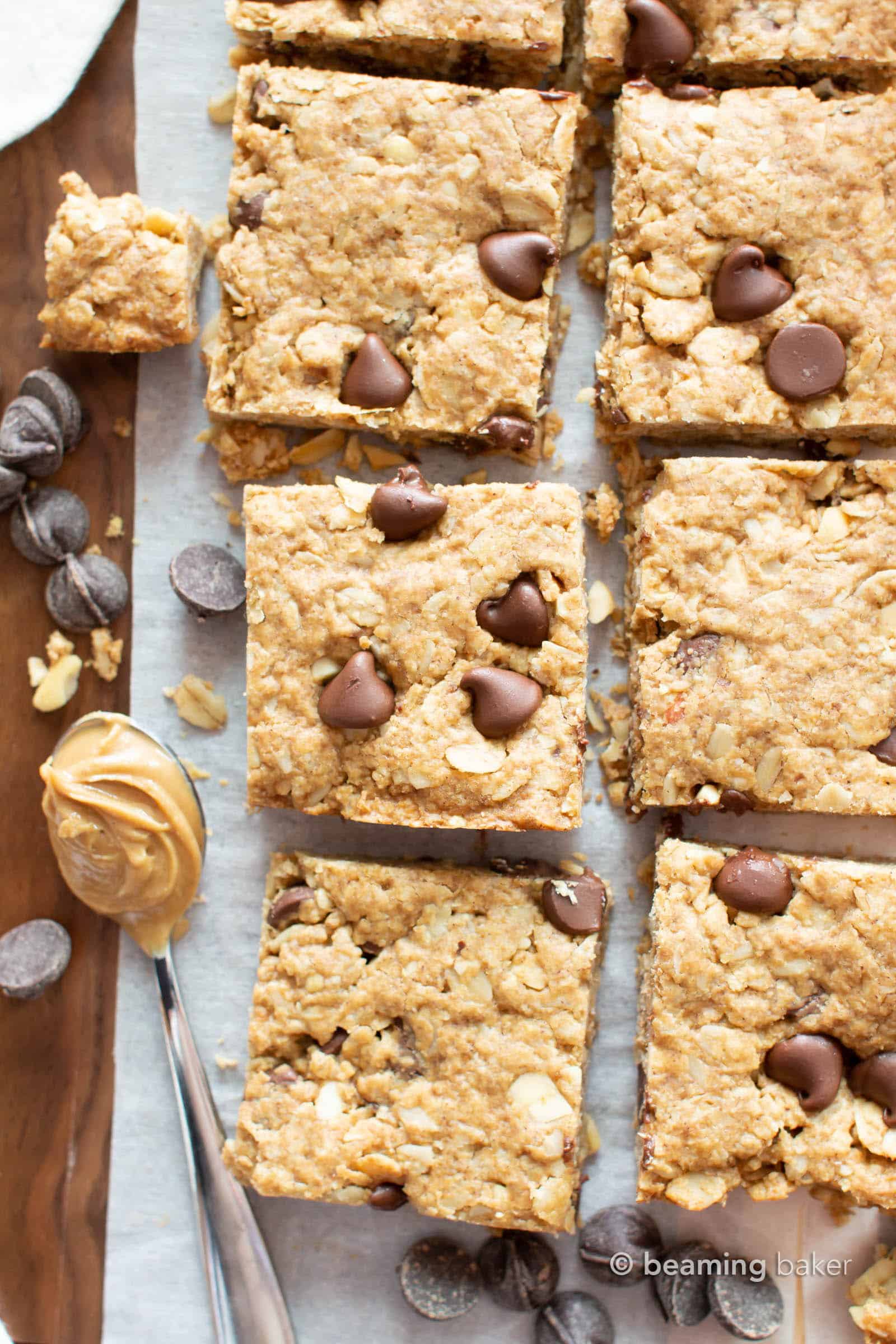 Peanut Butter Chocolate Chip Oatmeal Cookie Bars: this healthy oatmeal cookie bars recipe is packed with creamy peanut butter, fiber-rich oats and plant-based ingredients. Chewy & delicious cookies bars! Vegan, Gluten Free, Dairy-Free. #CookieBars #PeanutButter #Oatmeal #GlutenFree #Vegan | Recipe at BeamingBaker.com