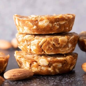 Easy Oatmeal Cups with Almond Butter: this 3 ingredient No Bake oatmeal cups recipe yields soft & chewy oatmeal cups—the perfect Quick ‘n Easy snack on-the-go! Vegan, Gluten Free. #PeanutButter #Oatmeal #NoBake #HealthySnacks | Recipe at BeamingBaker.com