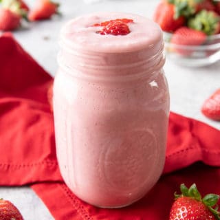 Strawberry Protein Shake Recipe: this easy vegan protein shake recipe is smooth, creamy & packed with strawberries! Healthy, High-Protein, Dairy-Free. #ProteinShake #PlantPowered #Strawberries #Healthy | Recipe at BeamingBaker.com