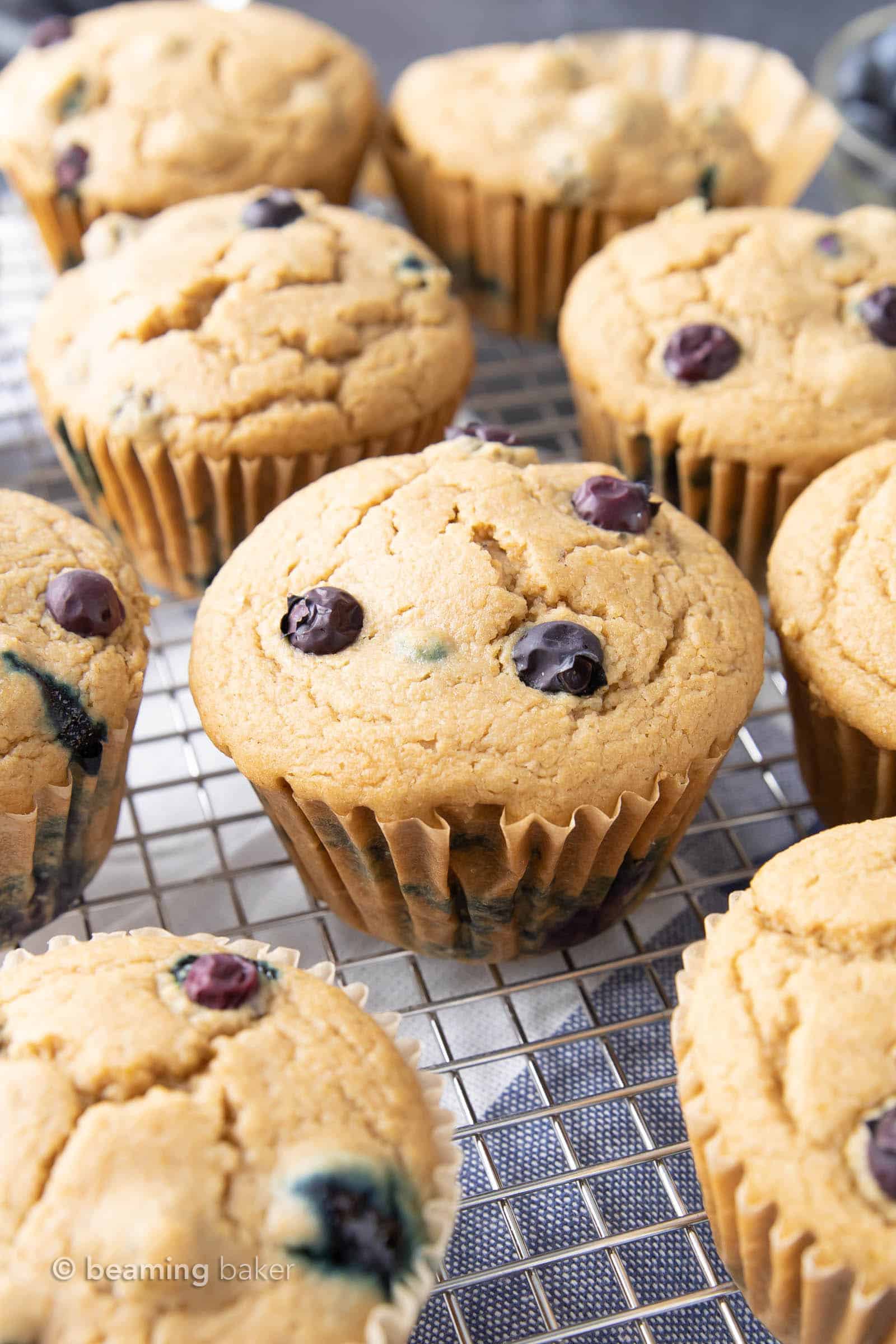 Easy Vegan Blueberry Muffins Recipe: this soft ‘n moist vegan blueberry muffins recipe yields fluffy, bright blueberry muffins. Gluten Free, Dairy-Free. #Vegan #Blueberry #Muffins #GlutenFree | Recipe at BeamingBaker.com