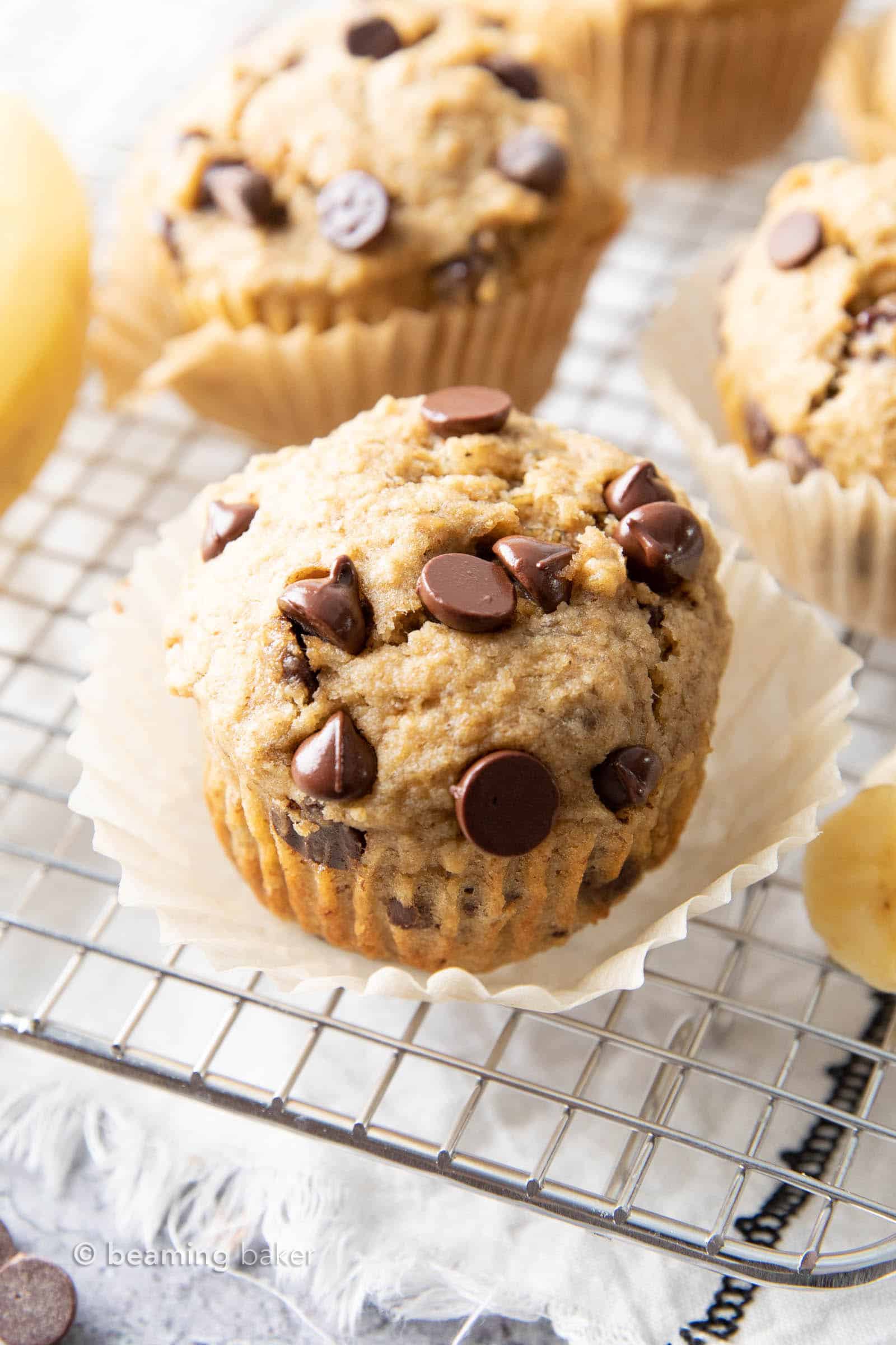 Healthy Banana Chocolate Chip Muffins: soft & moist banana bread muffins with sky-high, crispy tops, melty chocolate chips & BIG banana flavor. Whole ingredients, Plant-Based. #Muffins #Bananas #Chocolate #Healthy | Recipe at BeamingBaker.com