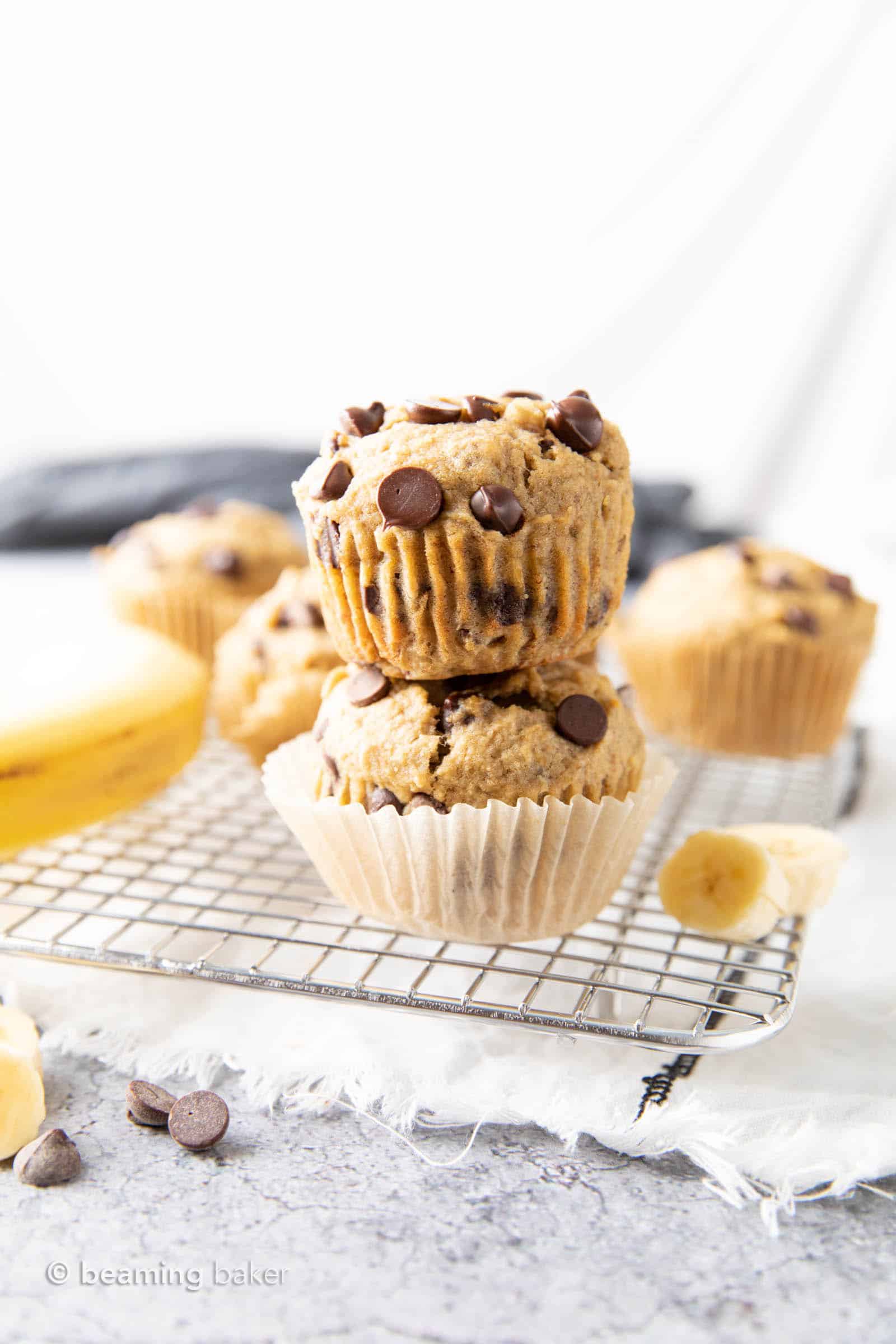 Healthy Banana Chocolate Chip Muffins: soft & moist banana bread muffins with sky-high, crispy tops, melty chocolate chips & BIG banana flavor. Whole ingredients, Plant-Based. #Muffins #Bananas #Chocolate #Healthy | Recipe at BeamingBaker.com
