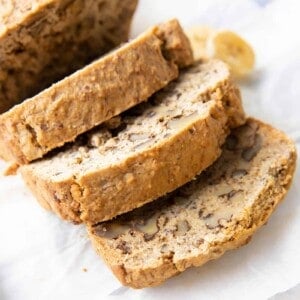 Easy Gluten Free Banana Bread Recipe: learn how to make gluten free banana bread that’s deliciously moist with a soft crumb & beautiful rise. Vegan, Dairy-Free, Plant-Based. #BananaBread #GlutenFree #Banana #Vegan | Recipe at BeamingBaker.com