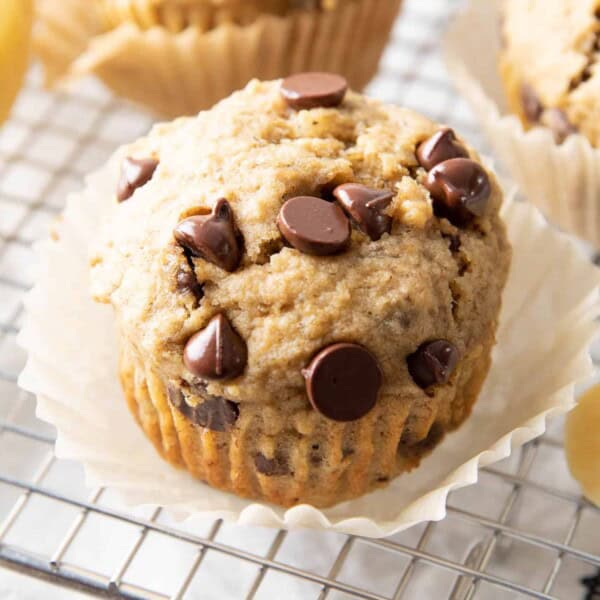 Healthy Banana Chocolate Chip Muffins: soft & moist banana bread muffins with sky-high, crispy tops, melty chocolate chips & BIG banana flavor. Whole ingredients, Plant-Based. #Muffins #Bananas #Chocolate #Healthy | Recipe at BeamingBaker.com