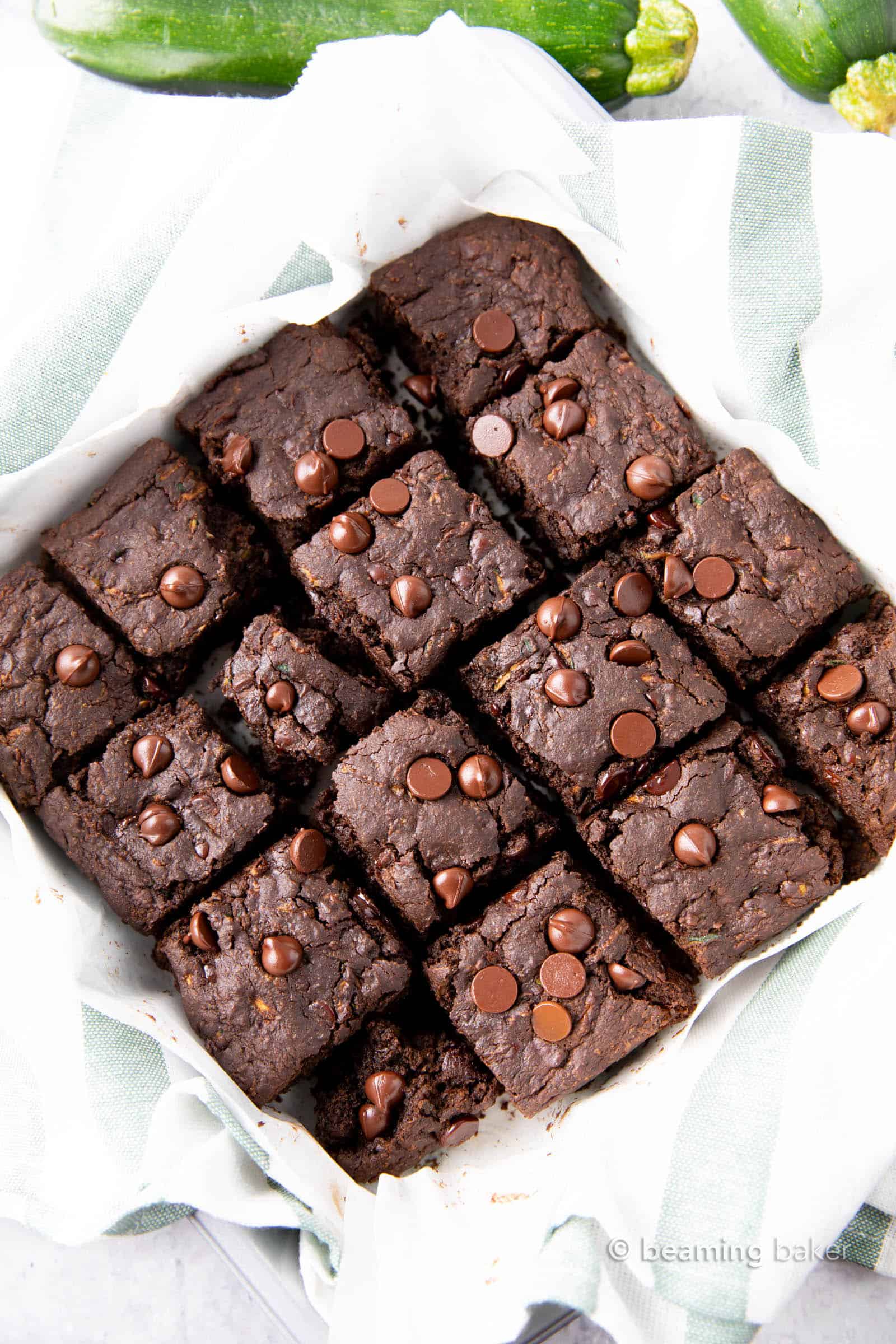 Healthy Zucchini Brownies (Vegan, GF): this chocolate zucchini brownies recipe yields moist, tender cakey brownies with rich chocolate flavor & a lightly fudgy texture. Vegan, Healthy. #Zucchini #ZucchiniBrownies #HealthyDesserts #Healthy #Vegan | Recipe at BeamingBaker.com