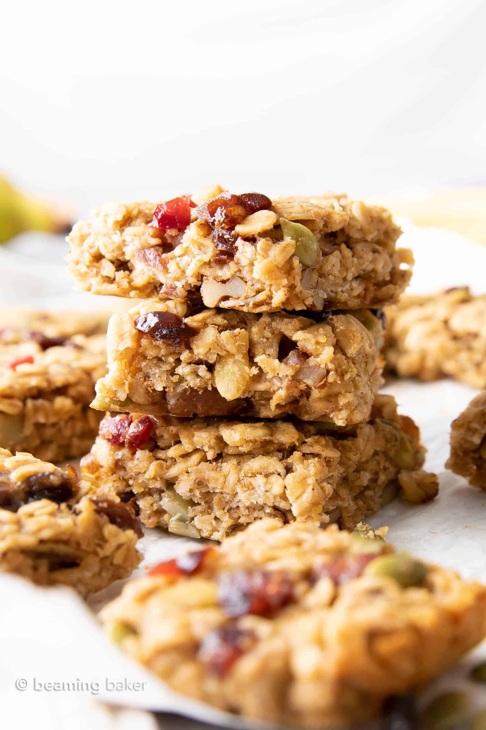 stack of three healthy breakfast bars surrounded by more bars.
