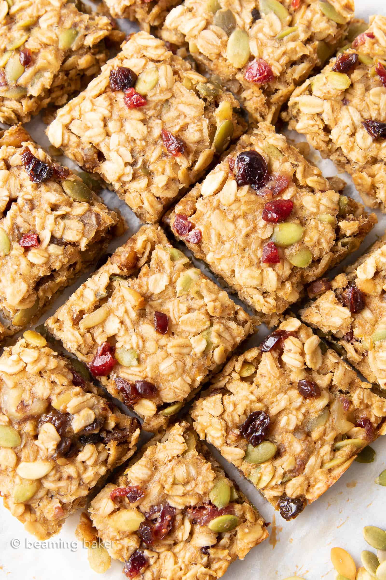 Healthy breakfast bars laying diagonally on a breakfast table with pumpkin seeds