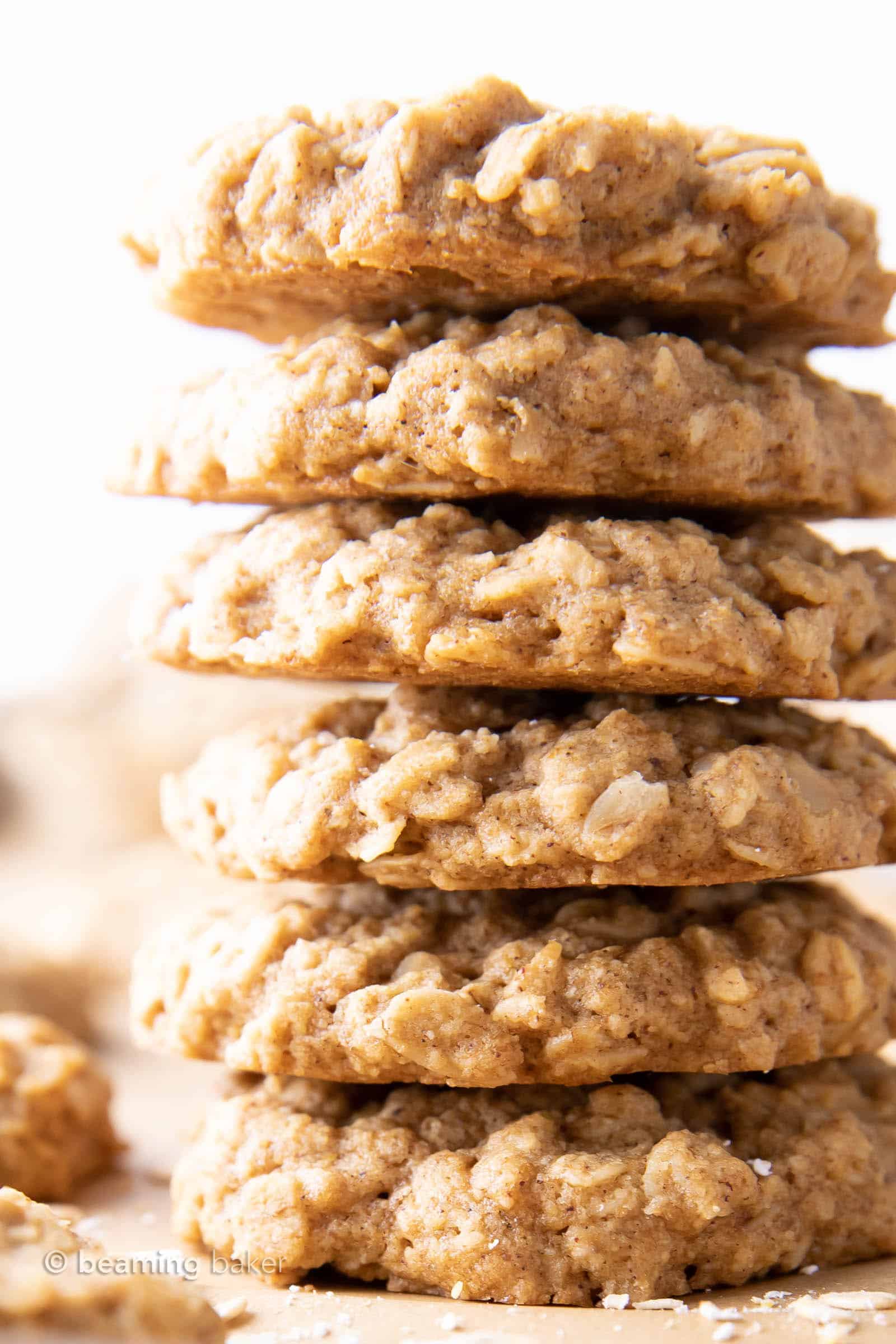 super closeup shot of a tall stack of healthy oatmeal cookies on a white backdrop
