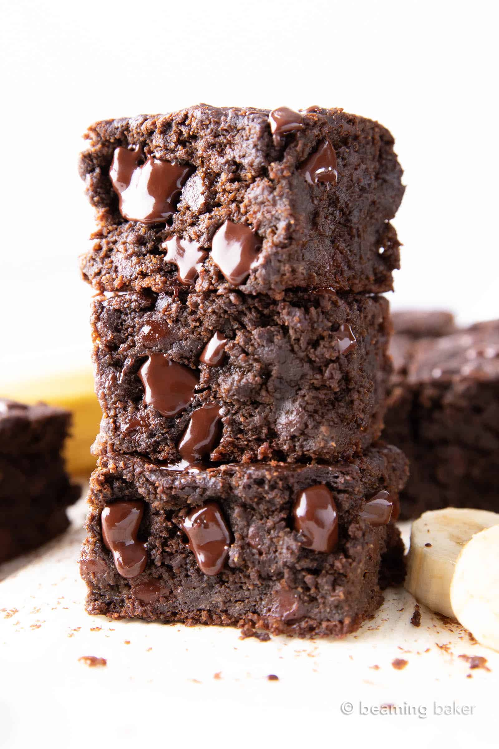 Vegan Banana Brownies: thick squares of super moist chocolate banana brownies. Melt-in-your-mouth fudgy and rich with a soft, tender crumb. The best banana brownie recipe! GF. #Vegan #Banana #Brownies #BananaBrownies | Recipe at BeamingBaker.com